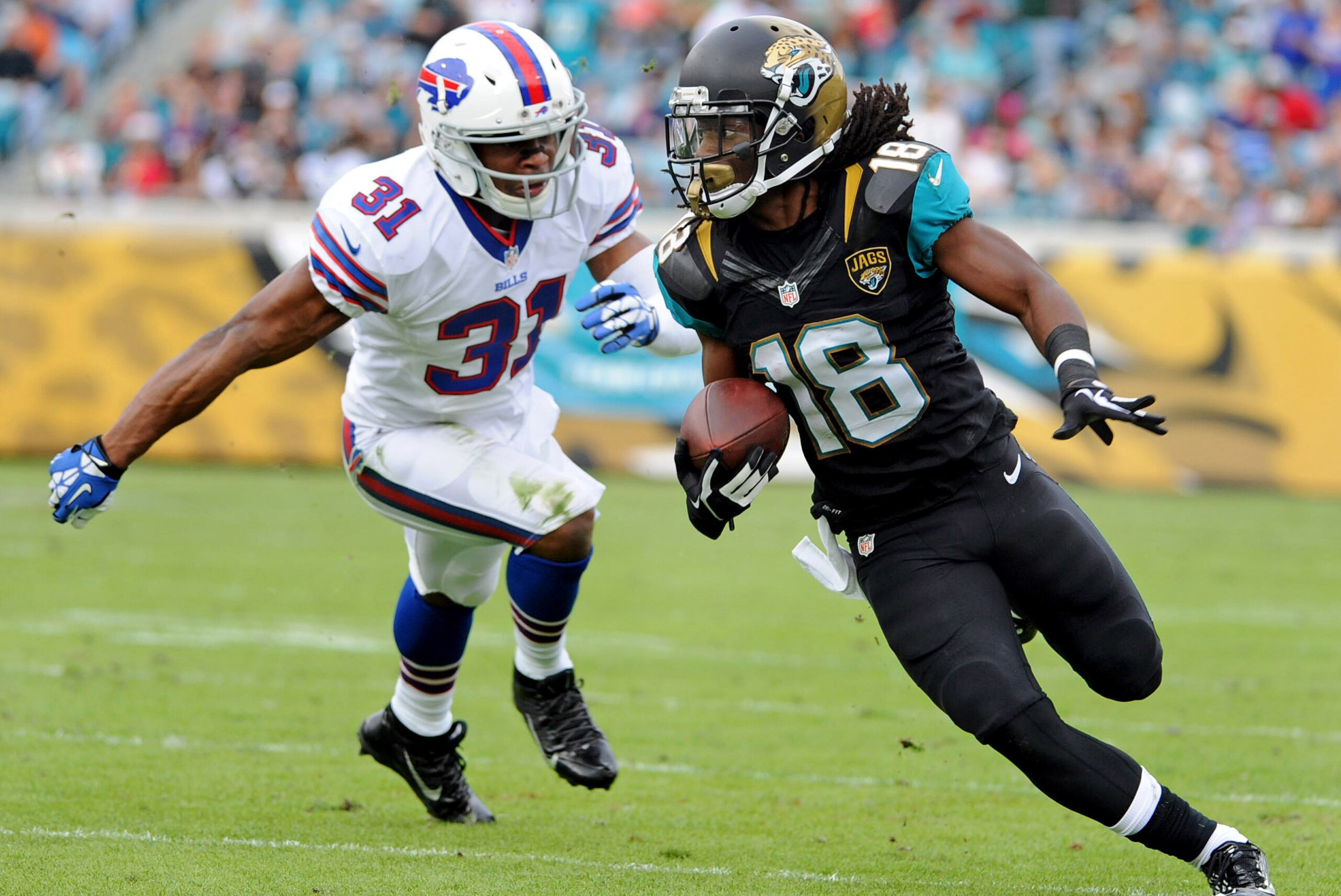 Dec 15, 2013; Jacksonville, FL, USA; Jacksonville Jaguars wide receiver Ace Sanders (18) runs the ball past Buffalo Bills free safety Jairus Byrd (31) during the first half at EverBank Field. Mandatory Credit: Melina Vastola-USA TODAY Sports