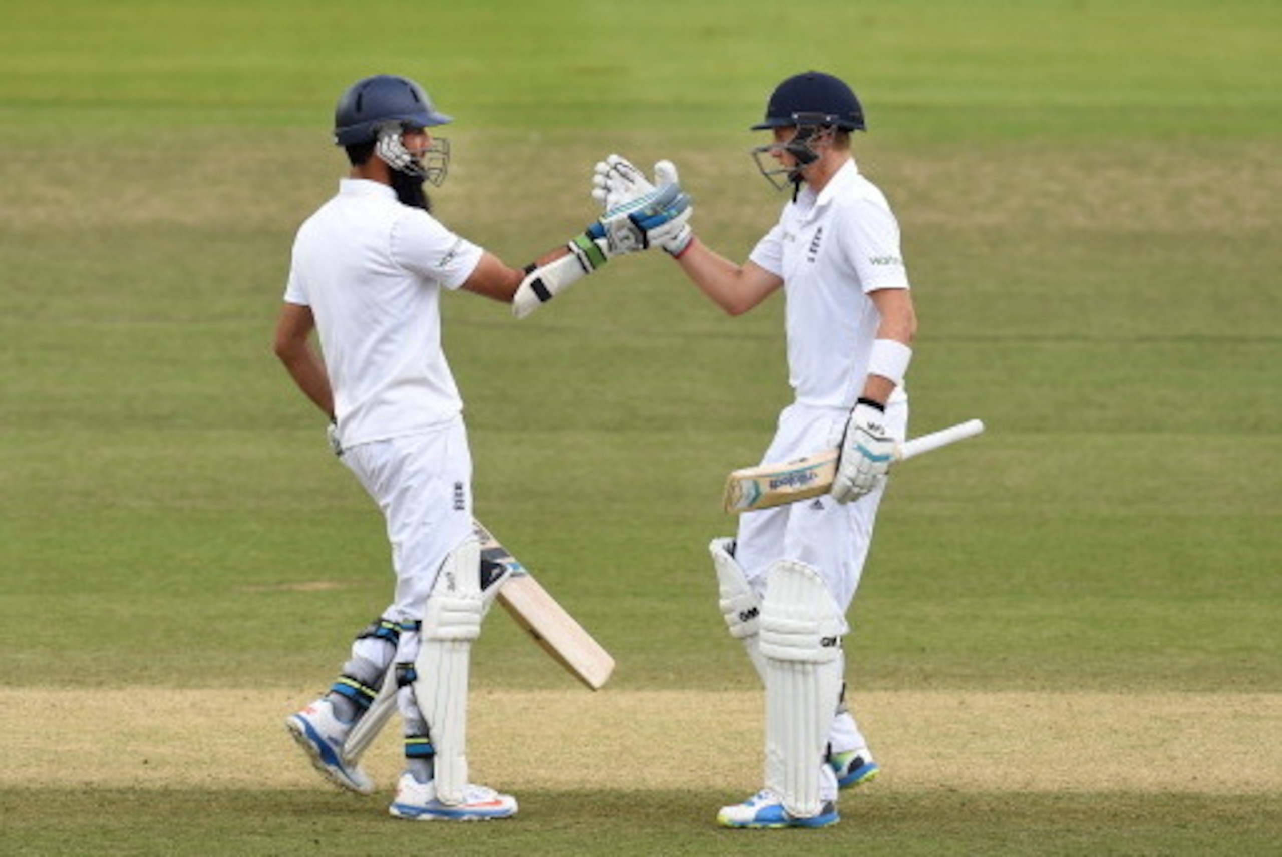 LONDON, ENGLAND - JULY 21:  England batsmen Joe Root (r) and Moeen Ali celebrate their century partnership during day five of 2nd Investec Test match between England and India at Lord's Cricket Ground on July 21, 2014 in London, United Kingdom.  (Photo by