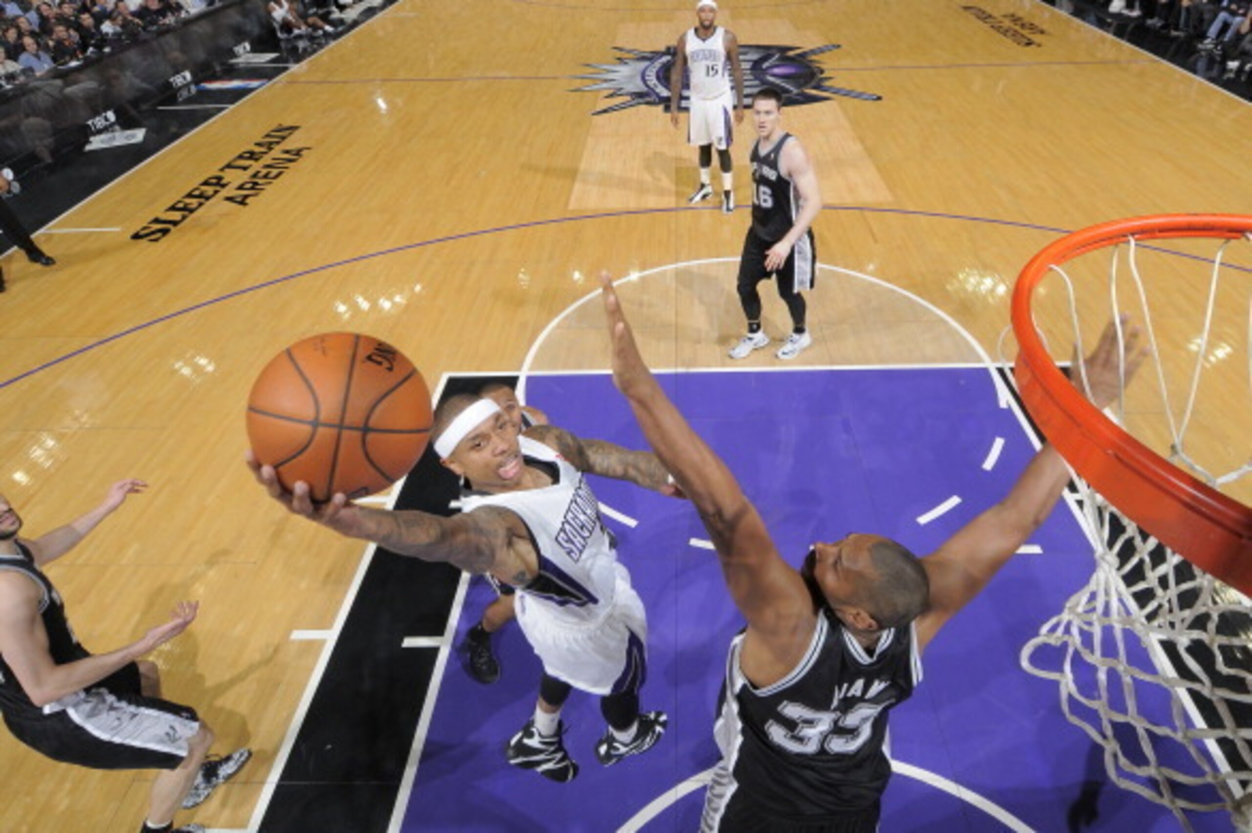 SACRAMENTO, CA - MARCH 21: Isaiah Thomas #22 of the Sacramento Kings shoots a layup against Boris Diaw #33 of the San Antonio Spurs on March 21, 2014 at Sleep Train Arena in Sacramento, California. NOTE TO USER: User expressly acknowledges and agrees that