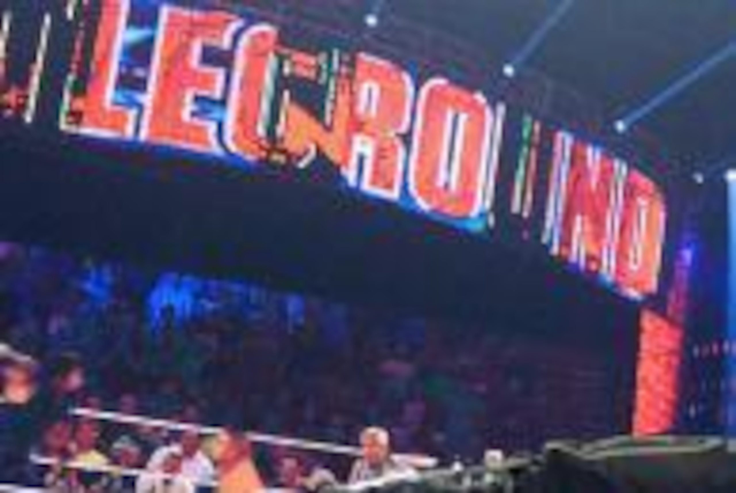 Roman Reigns takes out John Cena with a brutal superman punch.