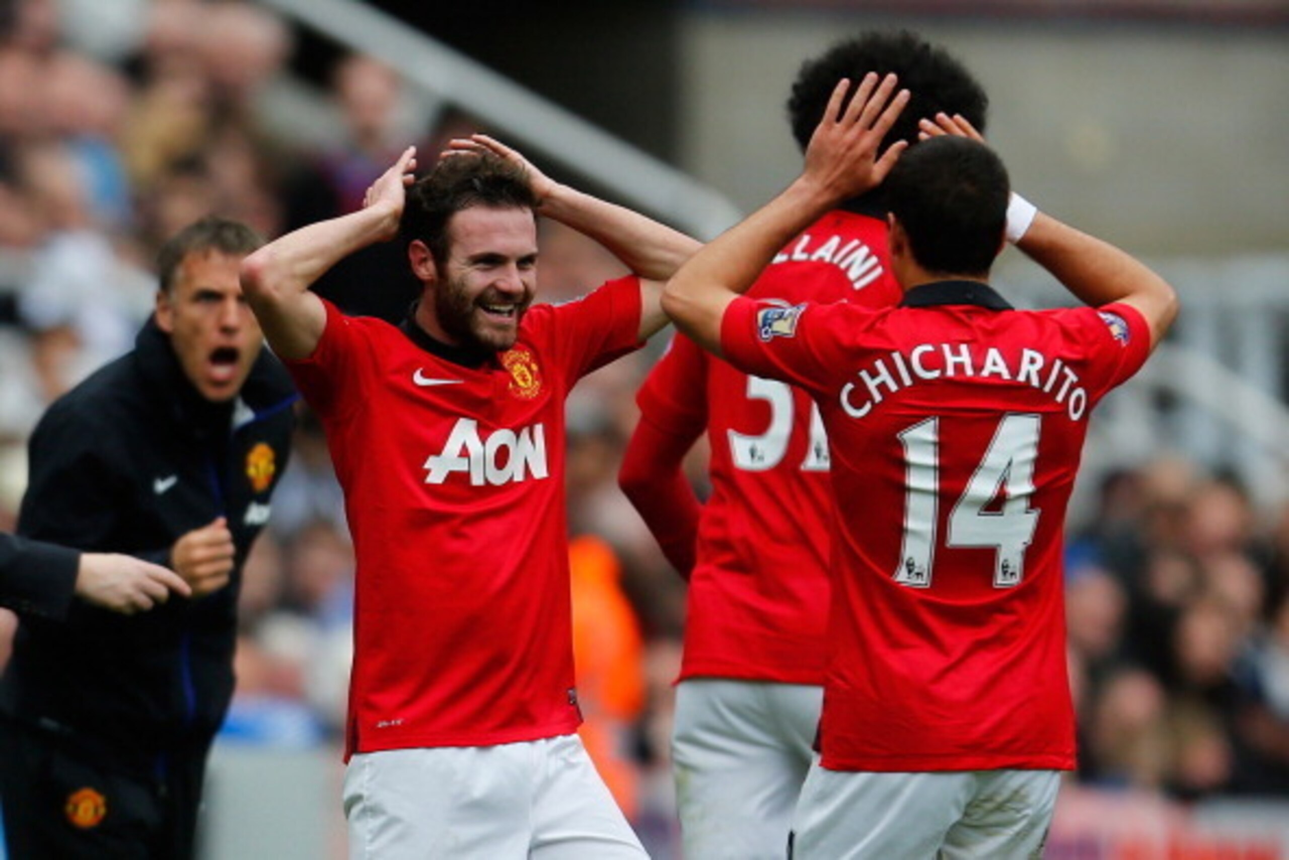 NEWCASTLE UPON TYNE, ENGLAND - APRIL 05: Juan Mata of Manchester United (L) celebrates with team mate Javier Hernandez after scoring their first goal during the Barclays Premier League match between Newcastle United and Manchester United at St James' Park