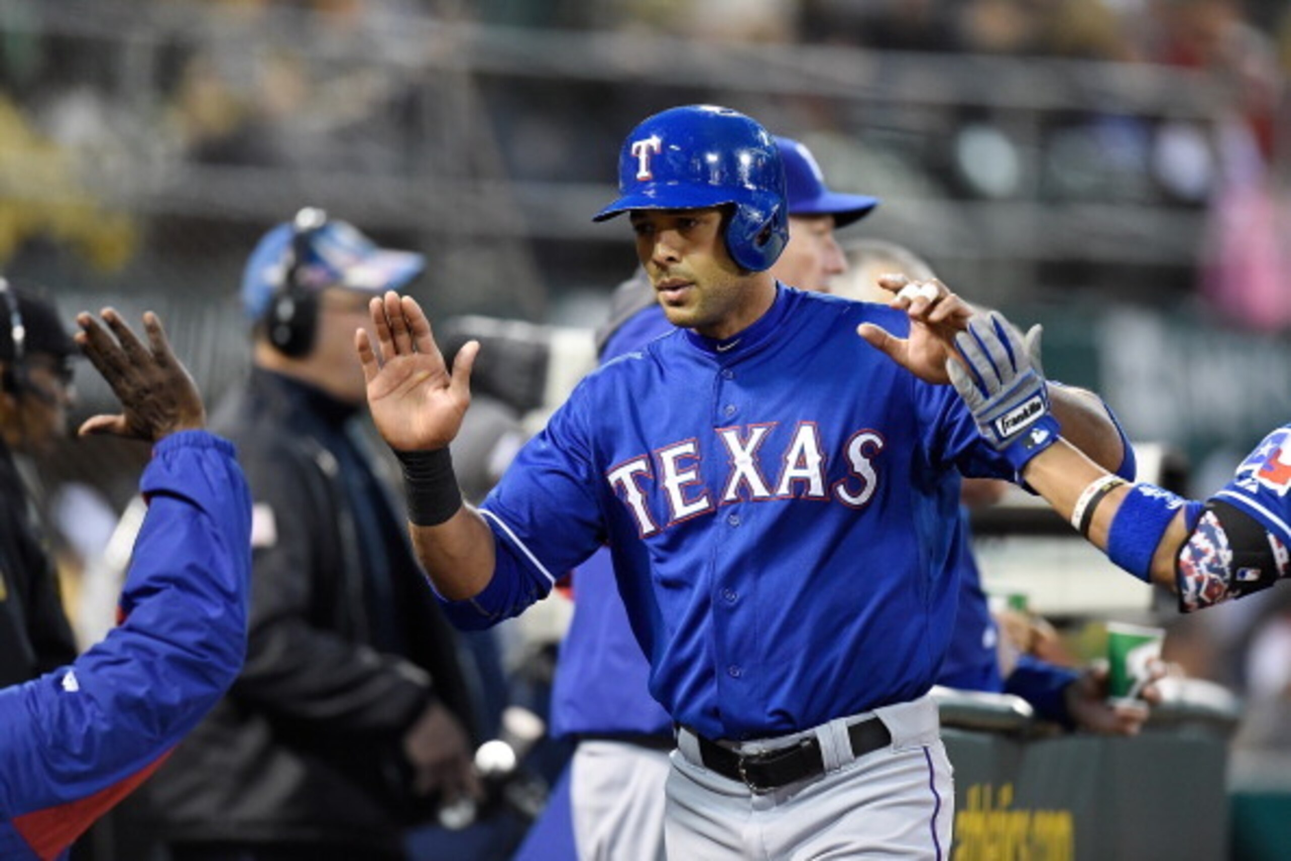 OAKLAND, CA - APRIL 22: Alex Rios #51 of the Texas Rangers is congratulated by teammates after he scored against the Oakland Athletics in the top of the third inning at O.co Coliseum on April 22, 2014 in Oakland, California. (Photo by Thearon W. Henders OAKLAND, CA - APRIL 22: Alex Rios #51 of the Texas Rangers is congratulated by teammates after he scored against the Oakland Athletics in the top of the third inning at O.co Coliseum on April 22, 2014 in Oakland, California. (Photo by Thearon W. Henders