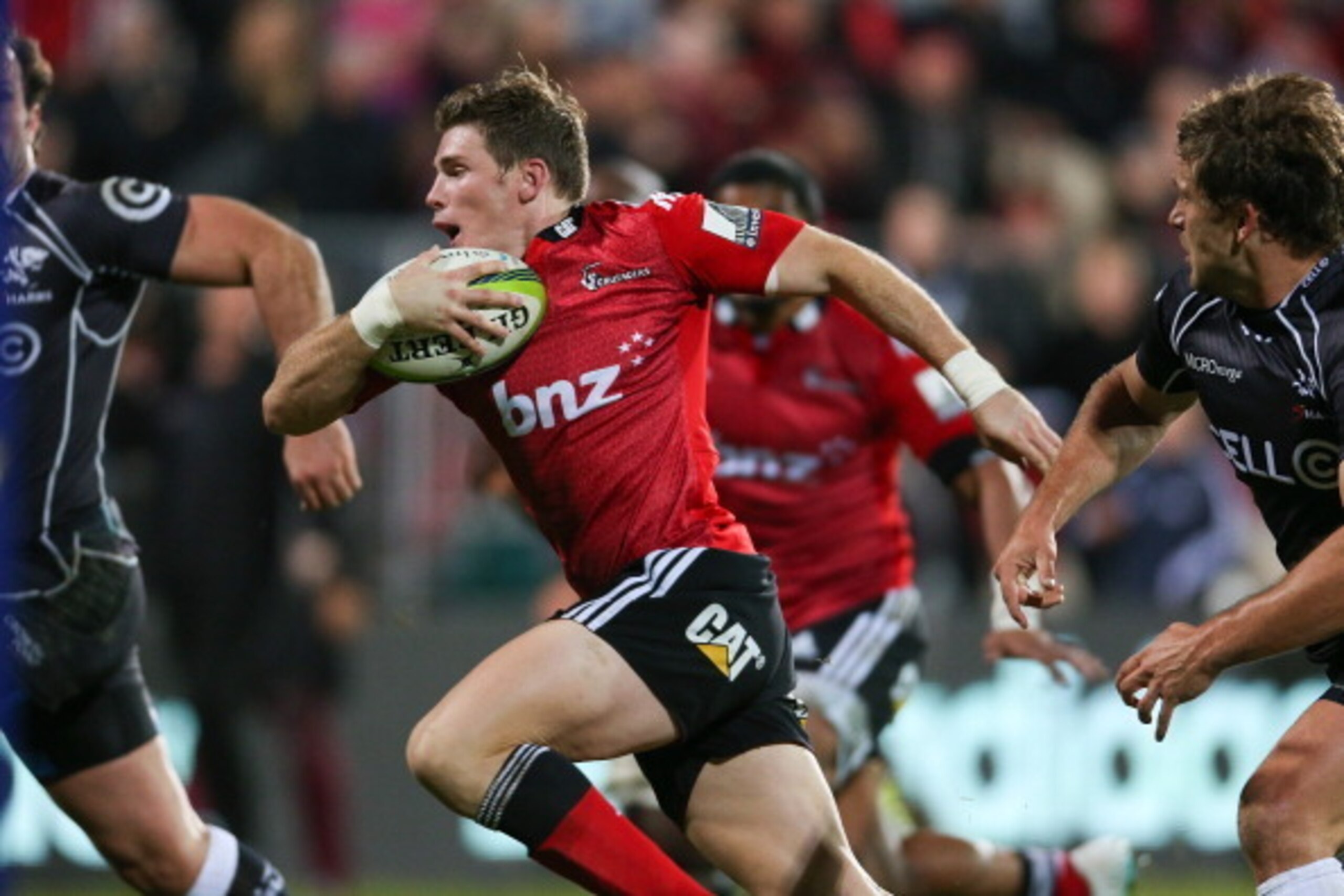 CHRISTCHURCH, NEW ZEALAND - MAY 17: Colin Slade of the Crusaders makes a break during the round 14 Super Rugby match between the Crusaders and the Sharks at AMI Stadium on May 17, 2014 in Christchurch, New Zealand.  (Photo by Martin Hunter/Getty Images)