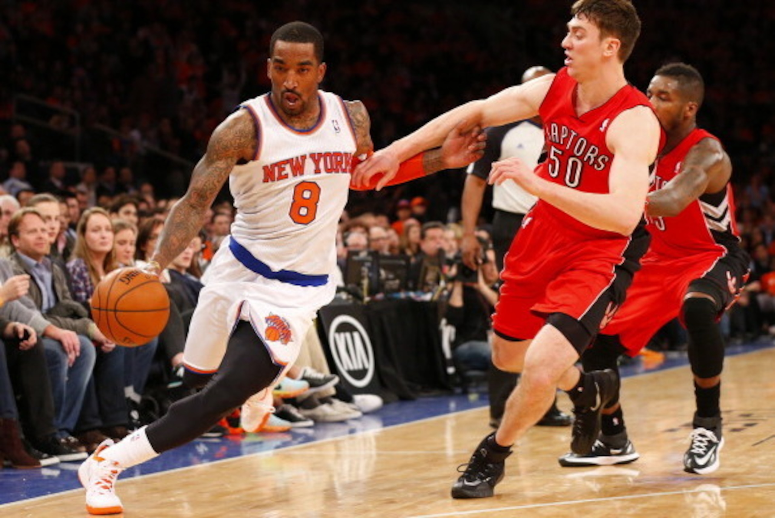 NEW YORK, NY - APRIL 16: J.R. Smith #8 of the New York Knicks is defended by Tyler Hansbrough #50 of the Toronto Raptors in the second half during an NBA basketball game at Madison Square Garden on April. 16, 2014 in New York City. The Knicks defeated the NEW YORK, NY - APRIL 16: J.R. Smith #8 of the New York Knicks is defended by Tyler Hansbrough #50 of the Toronto Raptors in the second half during an NBA basketball game at Madison Square Garden on April. 16, 2014 in New York City. The Knicks defeated the
