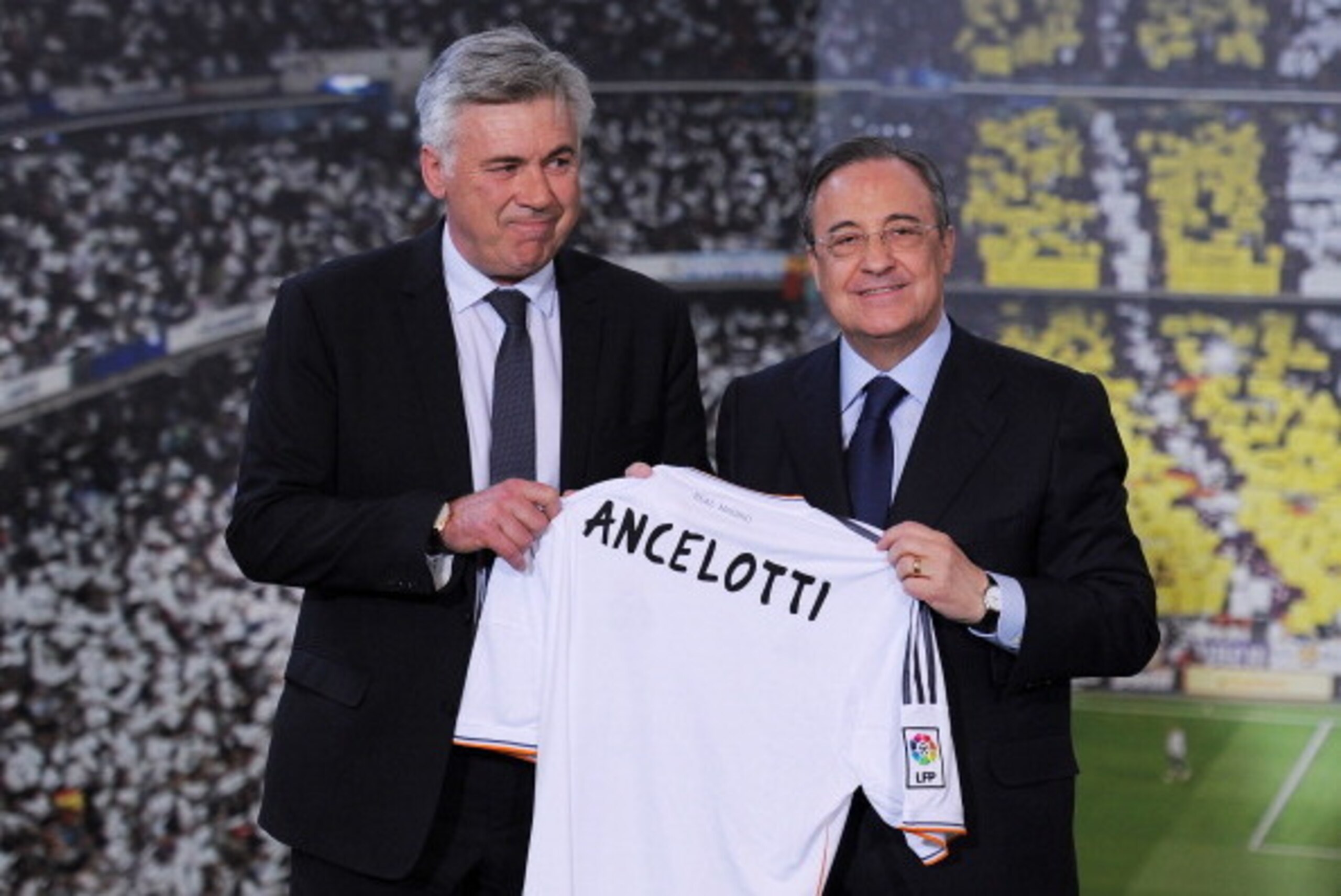 MADRID, SPAIN - JUNE 26:  Carlo Ancelotti (L) holds up a Real Madrid shirt as he stands alongside president Florentino Perez while being presented as the new head coach of Real Madrid at Estadio Bernabeu on June 26, 2013 in Madrid, Spain.  (Photo by Denis