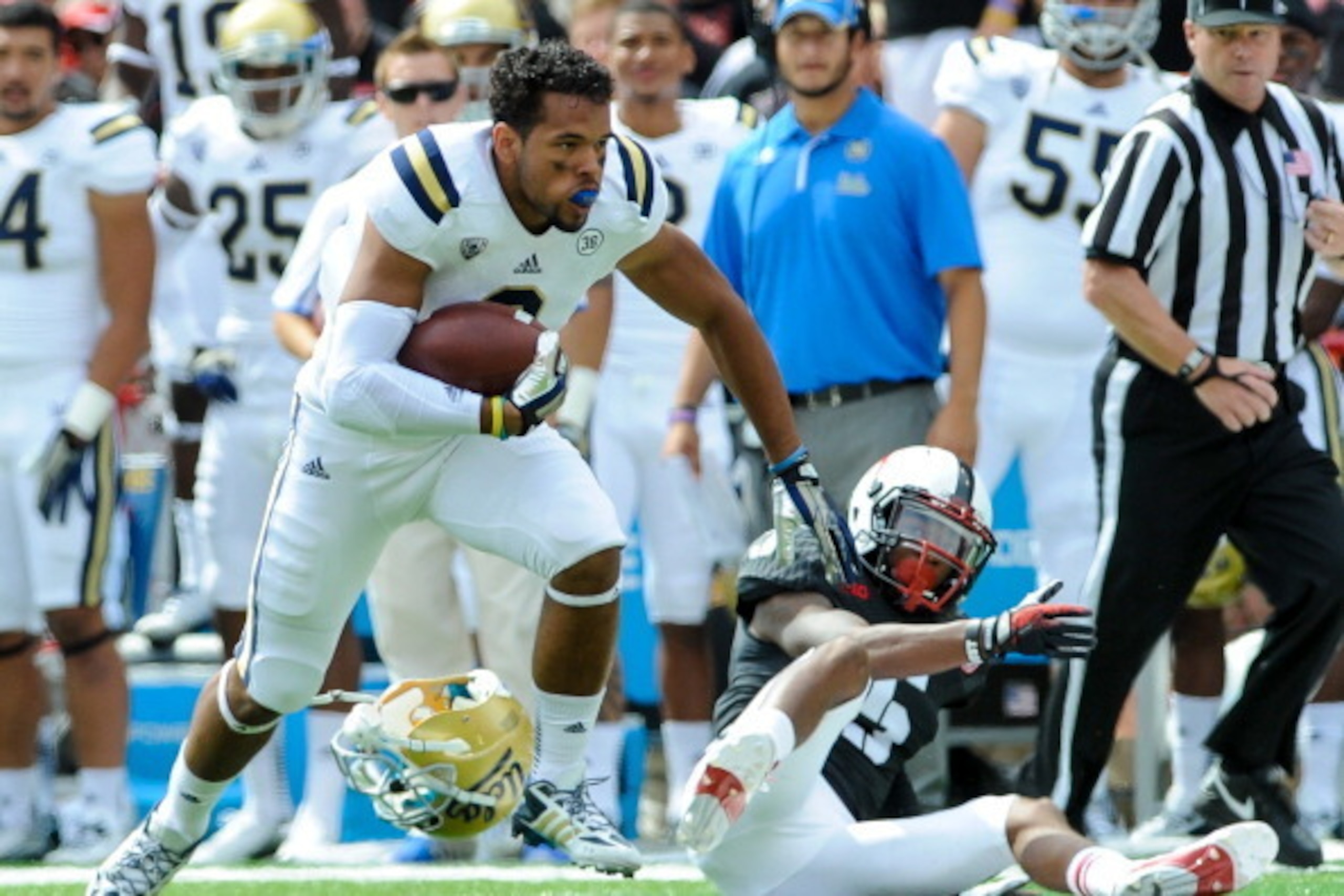 LINCOLN, NE - SEPTEMBER 14: Running back Jordon James #6 of the UCLA Bruins runs away from cornerback Josh Mitchell #5 of the Nebraska Cornhuskers during their game at Memorial Stadium on September 14, 2013 in Lincoln, Nebraska. (Photo by Eric Francis/Get