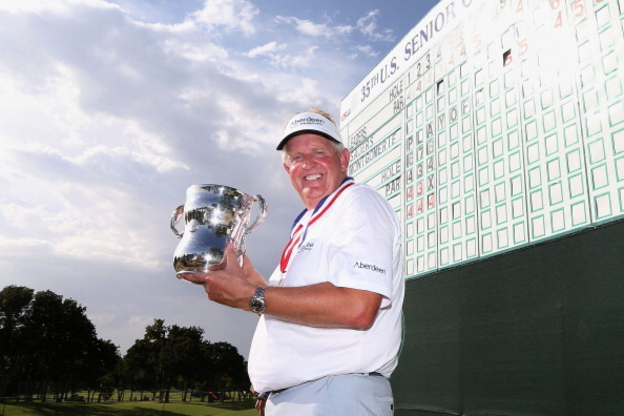 EDMOND, OK - JULY 13:  Colin Montgomerie of Scotland poses with the winner's trophy after winning the 2014 U.S. Senior Open Championship in the final round at Oak Tree National on July 13, 2014 in Edmond, Oklahoma.  (Photo by Christian Petersen/Getty Imag