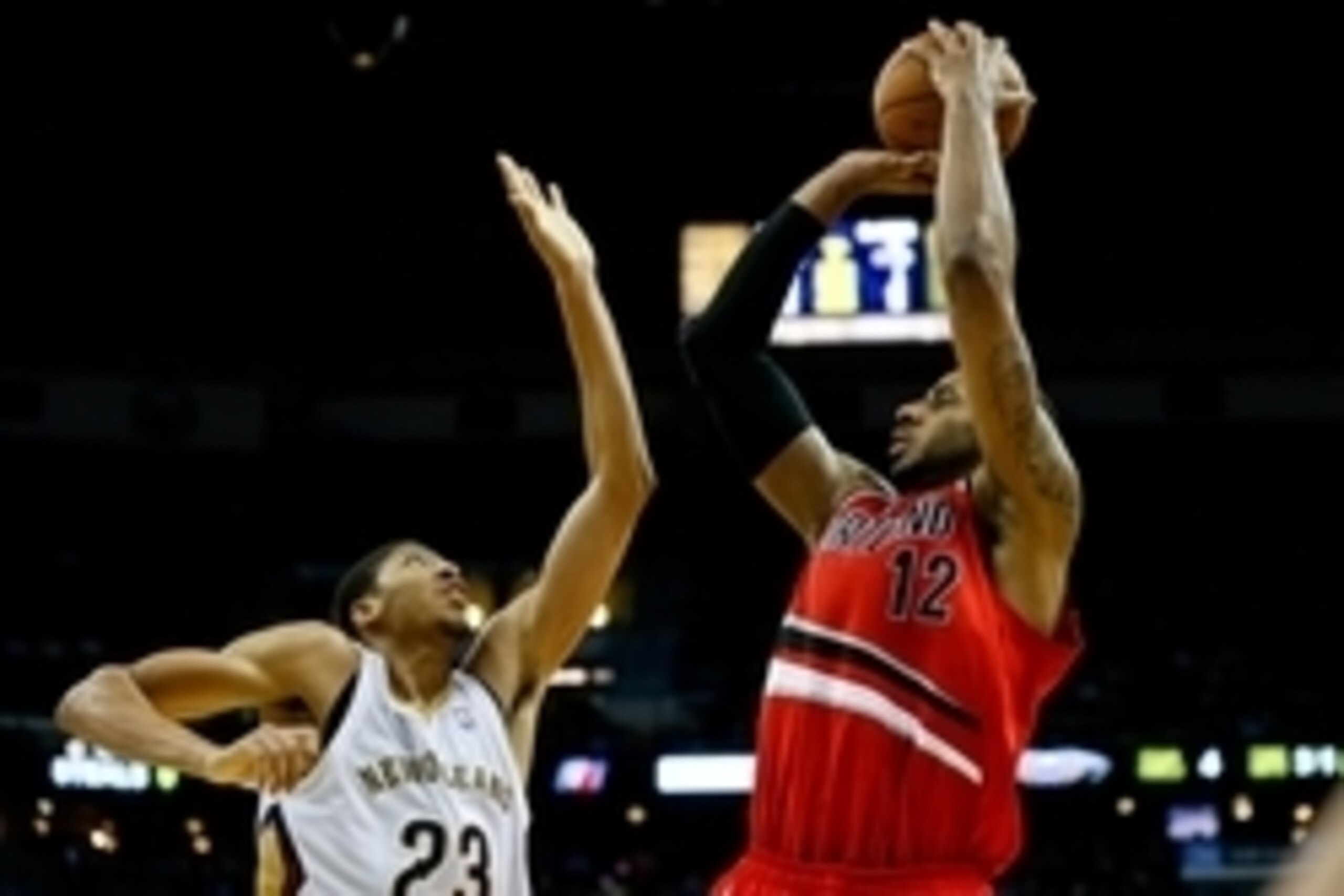 Dec 30, 2013; New Orleans, LA, USA; Portland Trail Blazers power forward LaMarcus Aldridge (12) shoots over New Orleans Pelicans power forward Anthony Davis (23) during the second half of a game at the New Orleans Arena. The Pelicans defeated the Trail Bl