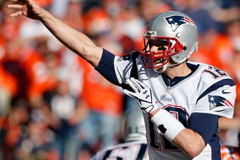 DENVER, CO - JANUARY 19:   Tom Brady #12 of the New England Patriots throws a pass against the Denver Broncos during the AFC Championship game at Sports Authority Field at Mile High on January 19, 2014 in Denver, Colorado.  (Photo by Kevin C. Cox/Getty Im