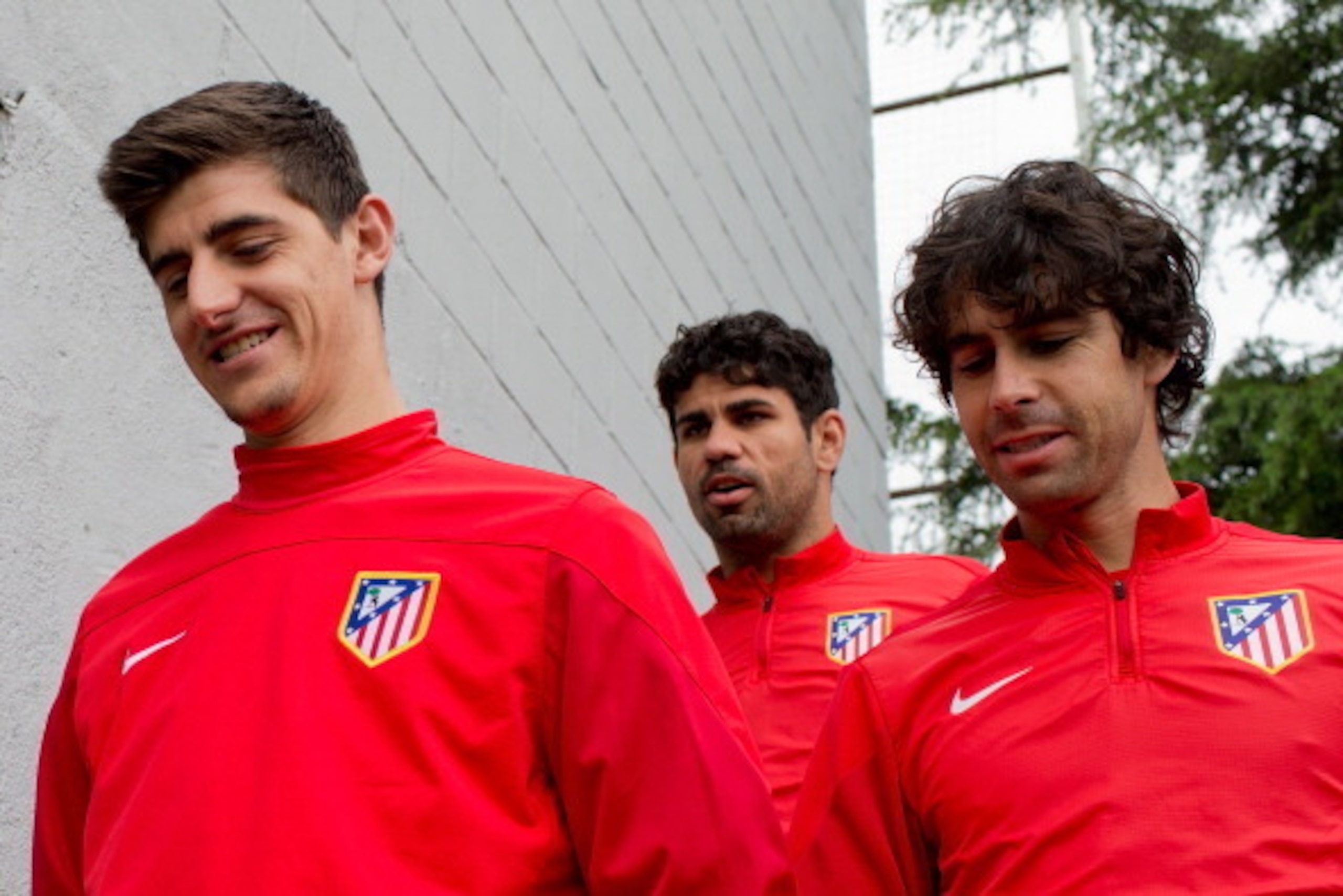 MAJADAHONDA, MADRID - APRIL 21:  Goalkeeper Thibaut Courtois (L) of Atletico de Madrid enters the pitch with teammates Diego Costa (2ndL); Arda Turan (2ndR) and Tiago Mendes (R)  prior to start the training session ahead of the UEFA Champions League Semif