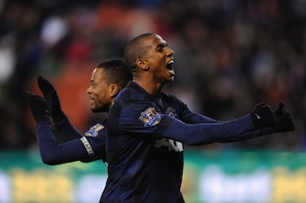 STOKE ON TRENT, ENGLAND - DECEMBER 18:  Patrice Evra of Manchester United celebrates scoring his team's second goal with team-mate Ashley Young (r) during the Capital One Cup Quarter Final match between Stoke City and Manchester United at the Britannia St