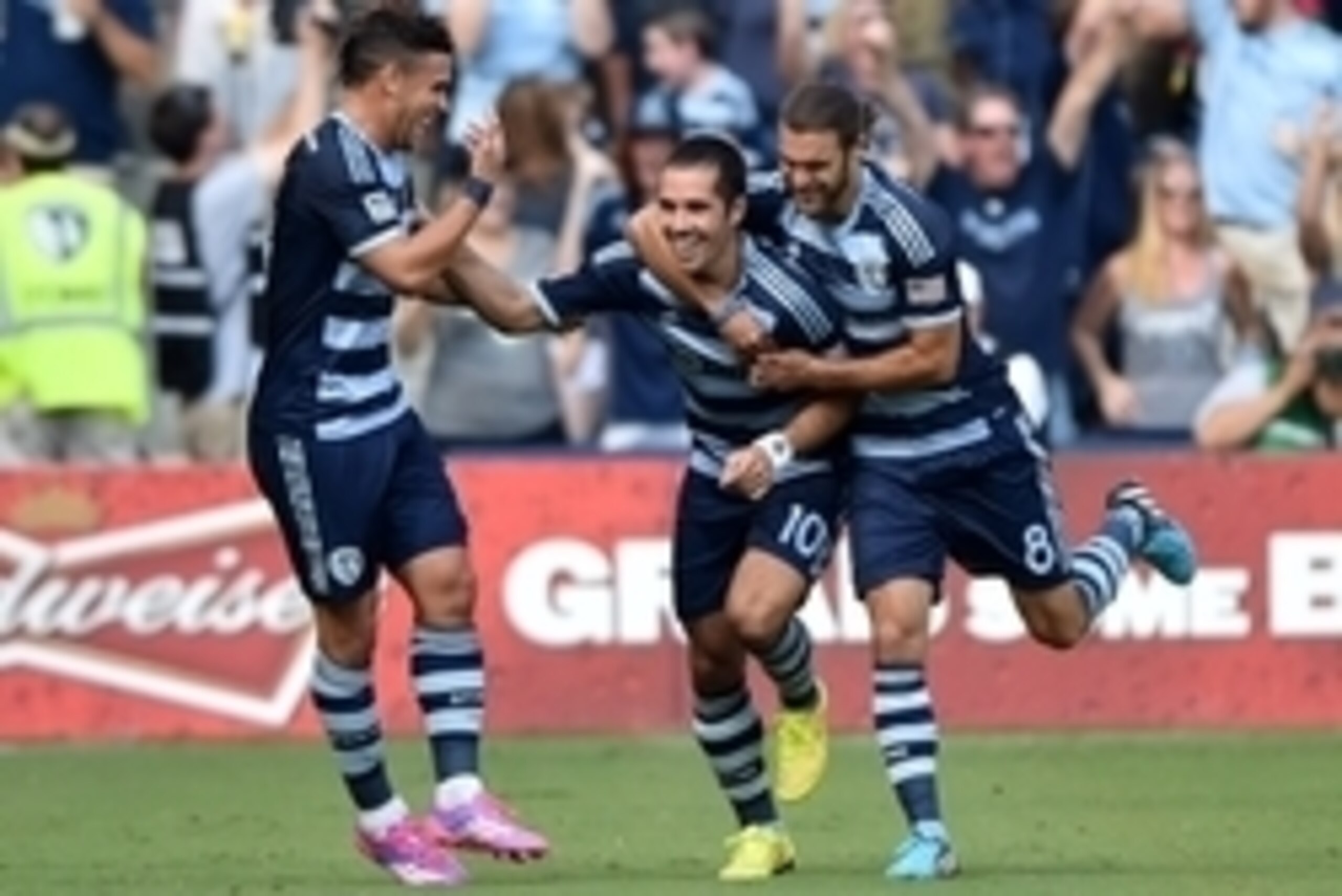 Jul 19, 2014; Kansas City, KS, USA; Sporting KC mid-fielder Benny Feilhaber (10) celebrates with teammates Graham Zusi (8) and Soony Saad (22) after scoring a goal off a free kick against the Los Angeles Galaxy during the first half at Sporting Park. Mand