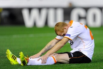 VALENCIA, SPAIN - MAY 01:  Jeremy Mathieu of Valencia CF sits dejected on the pitch after Stephane Mbia of Sevilla scored his team's first goal during the UEFA Europa League Semi Final second leg match between Valencia CF and Sevilla FC at Estadi de Mesta
