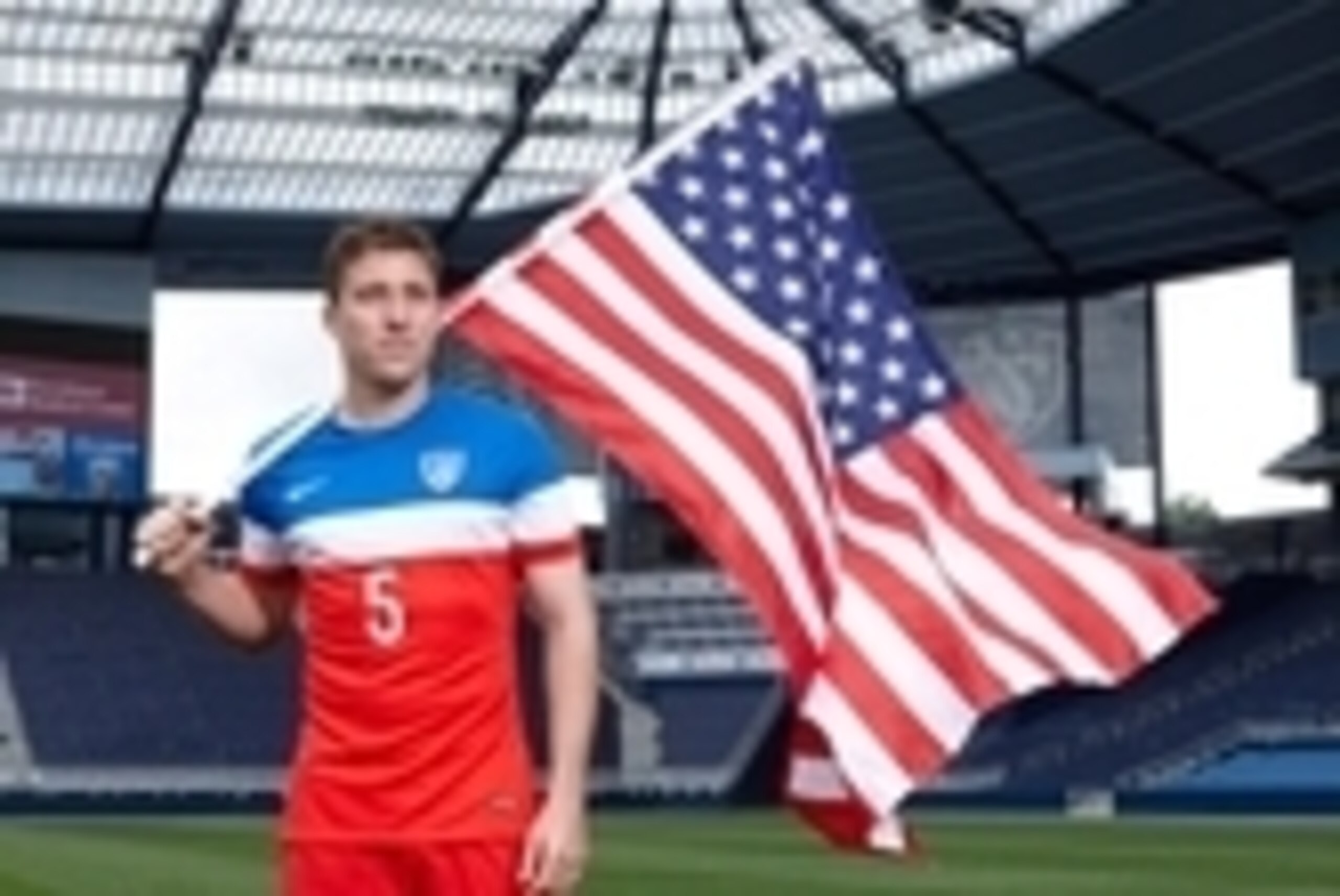 May 1, 2014; Kansas City, KS, USA; Matt Besler holds the US Flag while wearing the US National Soccer Team uniform at Sporting Park. Mandatory Credit: Gary Rohman/Sporting KC-USA TODAY Sports