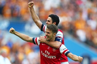 LONDON, ENGLAND - MAY 17:  Aaron Ramsey (L) and Mikel Arteta of Arsenal (R) celebrate victory after the FA Cup with Budweiser Final match between Arsenal and Hull City at Wembley Stadium on May 17, 2014 in London, England.  (Photo by Clive Mason/Getty Ima