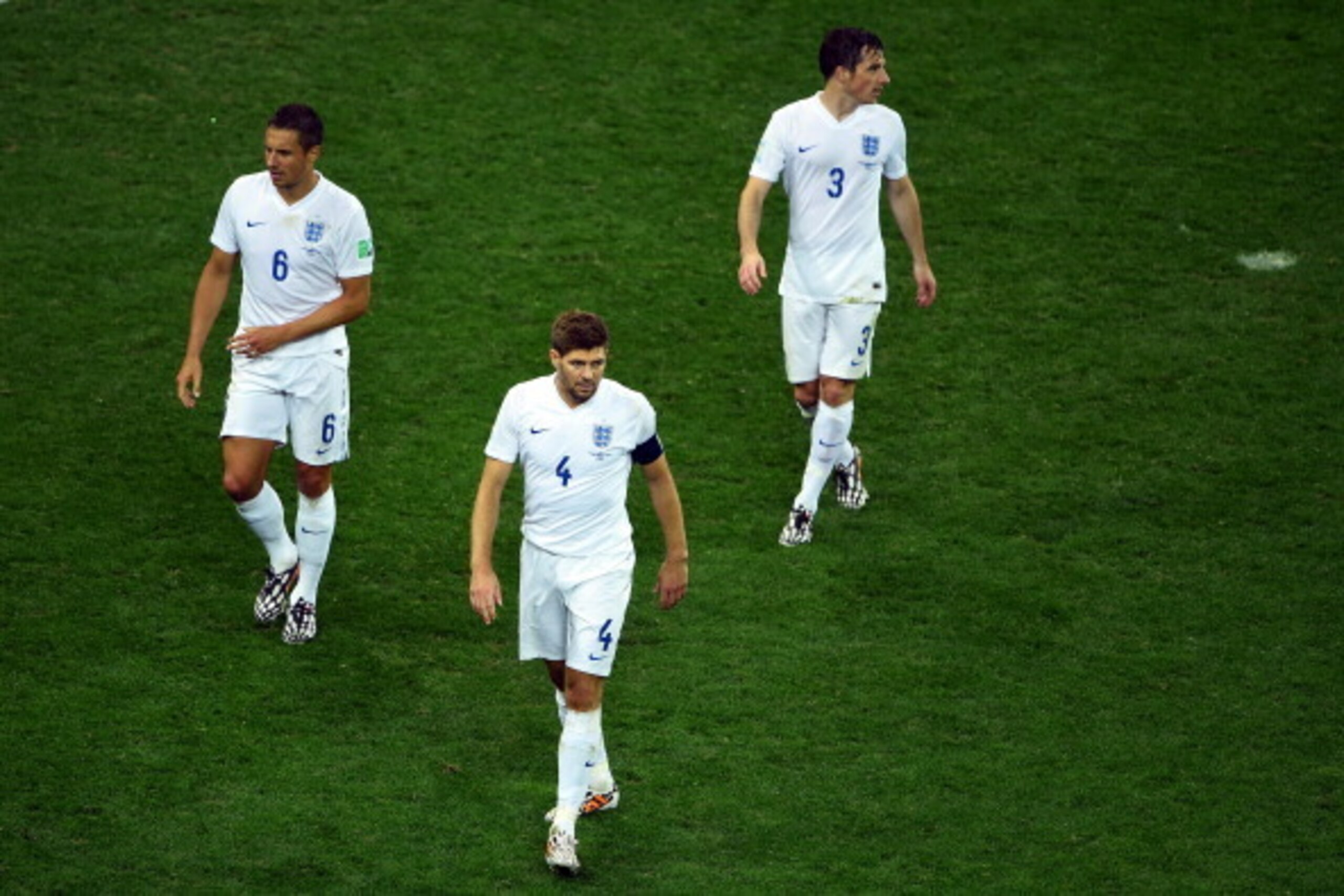 SAO PAULO, BRAZIL - JUNE 19: (L-R) A dejected Phil Jagielka, Steven Gerrard and Leighton Baines of England look on after losing to Uruguay 2-1 during the 2014 FIFA World Cup Brazil Group D match between Uruguay and England at Arena de Sao Paulo on June 19