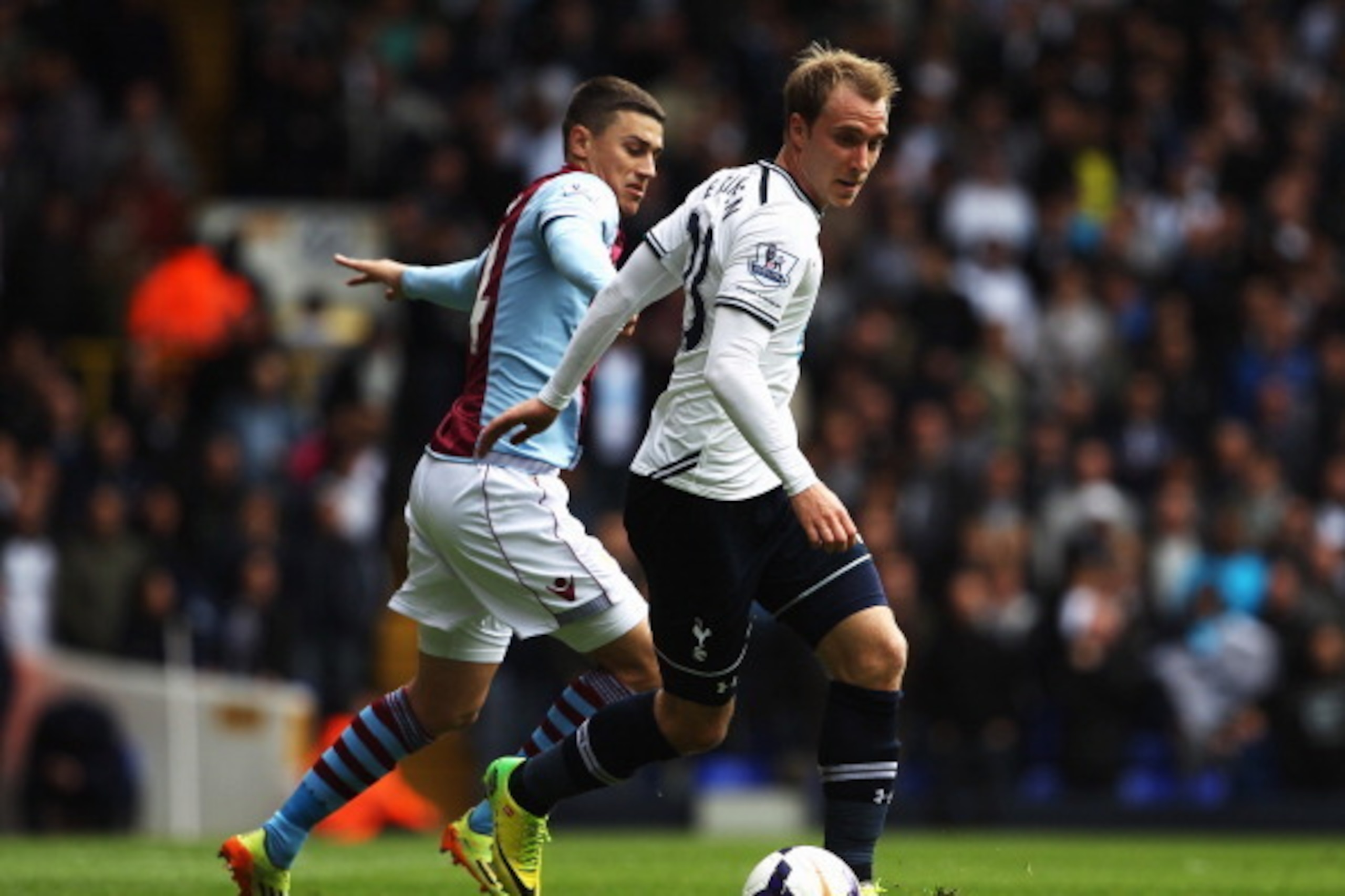 LONDON, ENGLAND - MAY 11:  Christian Eriksen (R) of Tottenham Hotspur holds off Matthew Lowton (L) of Aston Villa during the Barclays Premier League match between Tottenham Hotspur and Aston Villa at White Hart Lane on May 11, 2014 in London, England.  (P