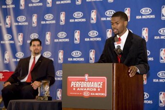 HOUSTON - APRIL 22: Aaron Brooks #0 of the Houston Rockets accepts his award as the 2009-2010 NBA Most Improved Player as Jesse Herrera of KIA Motors looks on on April 22, 2010 in Houston, Texas.  NOTE TO USER: User expressly acknowledges and agrees that,