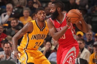 INDIANAPOLIS - DECEMBER 20: James Harden #13 of the Houston Rockets controls the ball against Paul George #24 of the Indiana Pacers at Bankers Life Fieldhouse on December 20, 2013 in Indianapolis, Indiana.  NOTE TO USER: User expressly acknowledges and ag