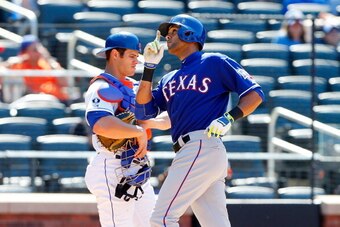 NEW YORK, NY - JULY 06:  Alex Rios #51 of the Texas Rangers celebrates his eighth inning home run as Anthony Recker #20 of the New York Mets looks on at Citi Field on July 6, 2014 in the Flushing neighborhood of the Queens borough of New York City.  (Phot