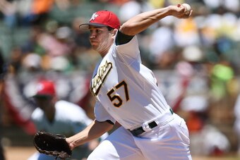 OAKLAND, CA - JULY 04:  Tommy Milone #57 of the Oakland Athletics pitches in the top of the first inning against the Toronto Blue Jays at O.co Coliseum on July 4, 2014 in Oakland, California.  (Photo by Thearon W. Henderson/Getty Images)