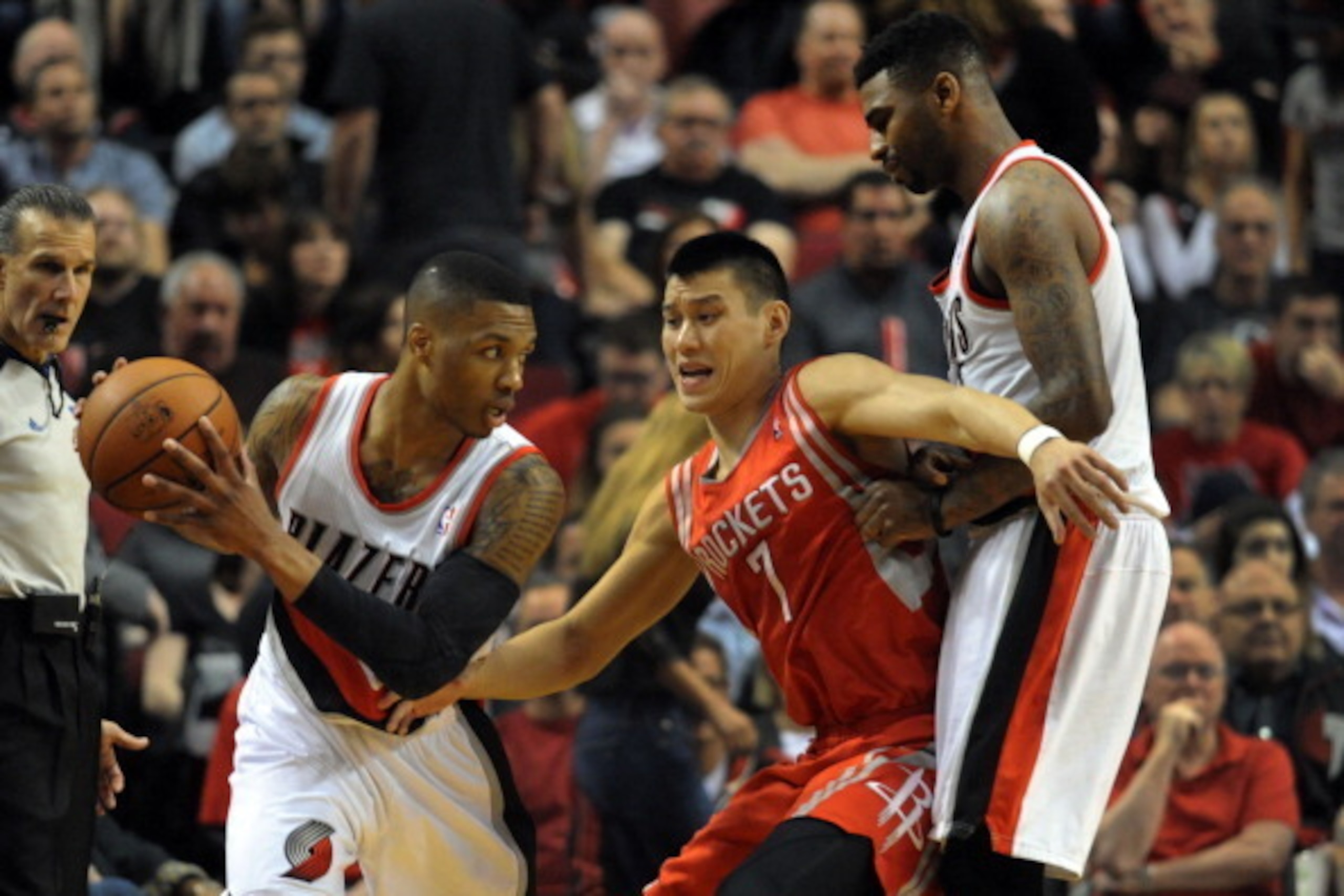 PORTLAND, OR - APRIL  27: Jeremy Lin #7 of the Houston Rockets works around a pick set by Dorell Wright #1 of the Portland Trail Blazers to get to Damian Lillard #0 of the Portland Trail Blazers in the first quarter of Game Four of the Western Conference 