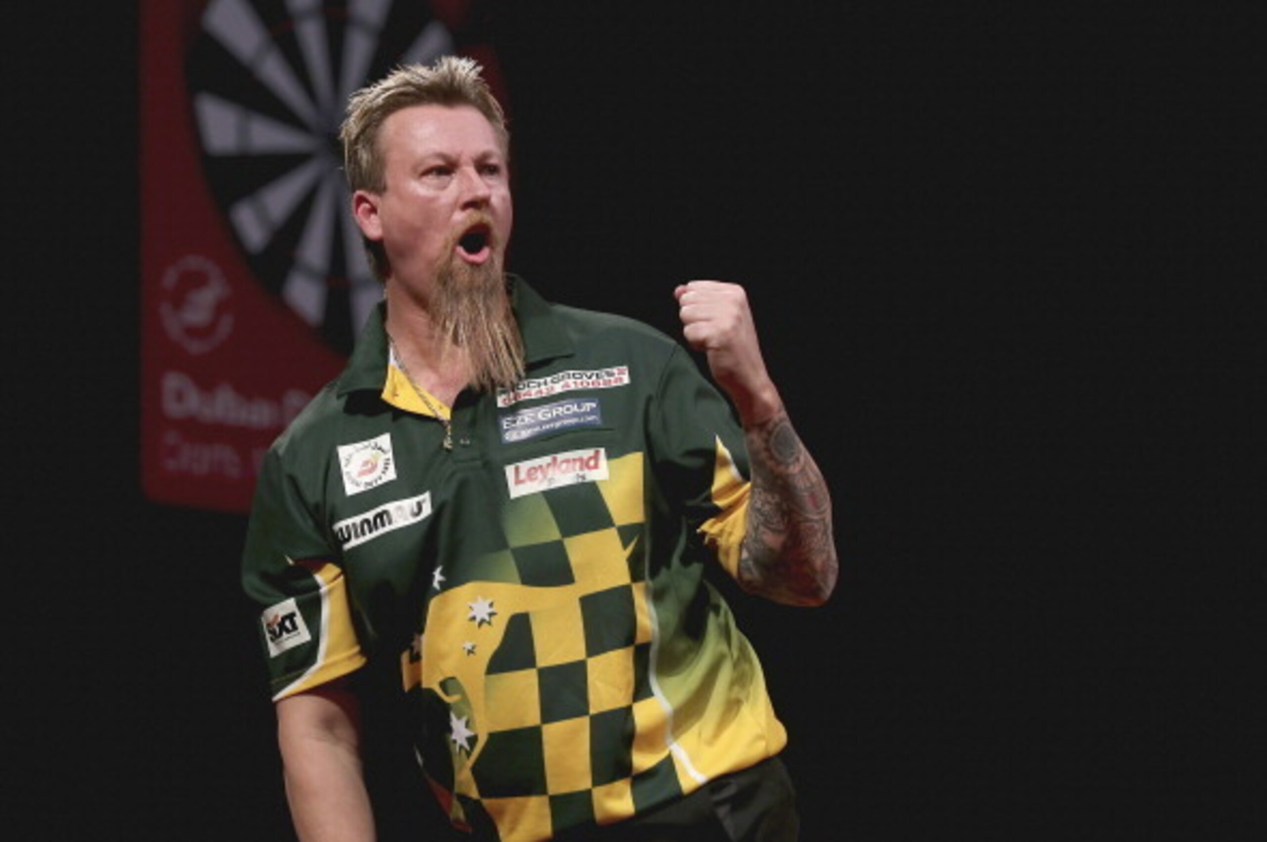 DUBAI, UNITED ARAB EMIRATES - MAY 29:  Simon Whitlock of Australia celebrates winning a point against  Dave Chisnall  of England during the 2014 Dubai Duty Free Darts Masters Quarter-Final match  at Dubai Duty Free Tennis Stadium, Irish Village on May 29,