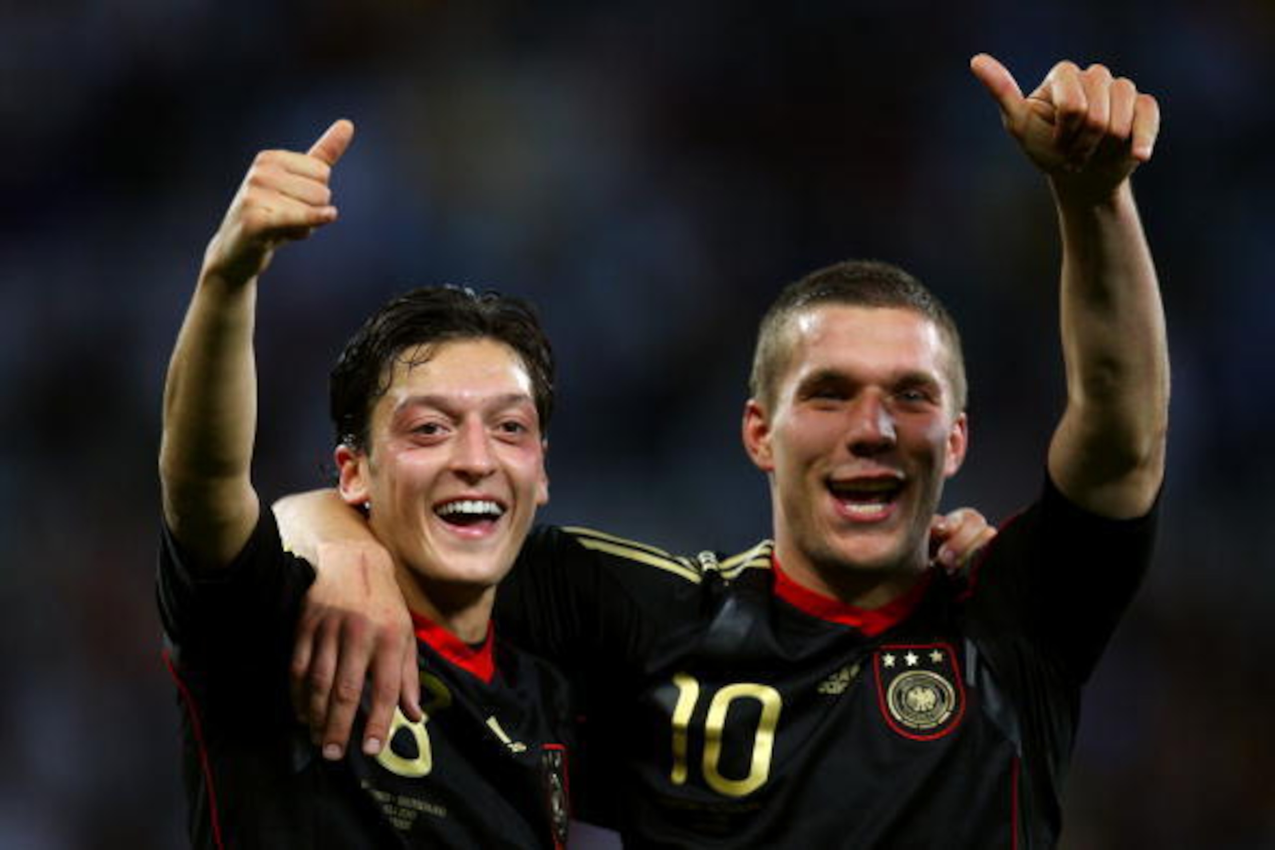 CAPE TOWN, SOUTH AFRICA - JULY 03: Mesut Oezil and Lukas Podolski of Germany celebrate victory following the 2010 FIFA World Cup South Africa Quarter Final match between Argentina and Germany at Green Point Stadium on July 3, 2010 in Cape Town, South Afr CAPE TOWN, SOUTH AFRICA - JULY 03: Mesut Oezil and Lukas Podolski of Germany celebrate victory following the 2010 FIFA World Cup South Africa Quarter Final match between Argentina and Germany at Green Point Stadium on July 3, 2010 in Cape Town, South Afr