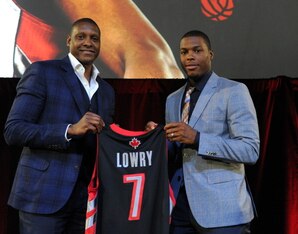TORONTO, ON - JULY 10:  Masai Ujiri and Kyle Lowry during the press conference after his singing of a contract extension with the Toronto Raptors at the Air Canada Centre on July 10, 2014 in Toronto, Ontario, Canada. NOTE TO USER: User expressly acknowled