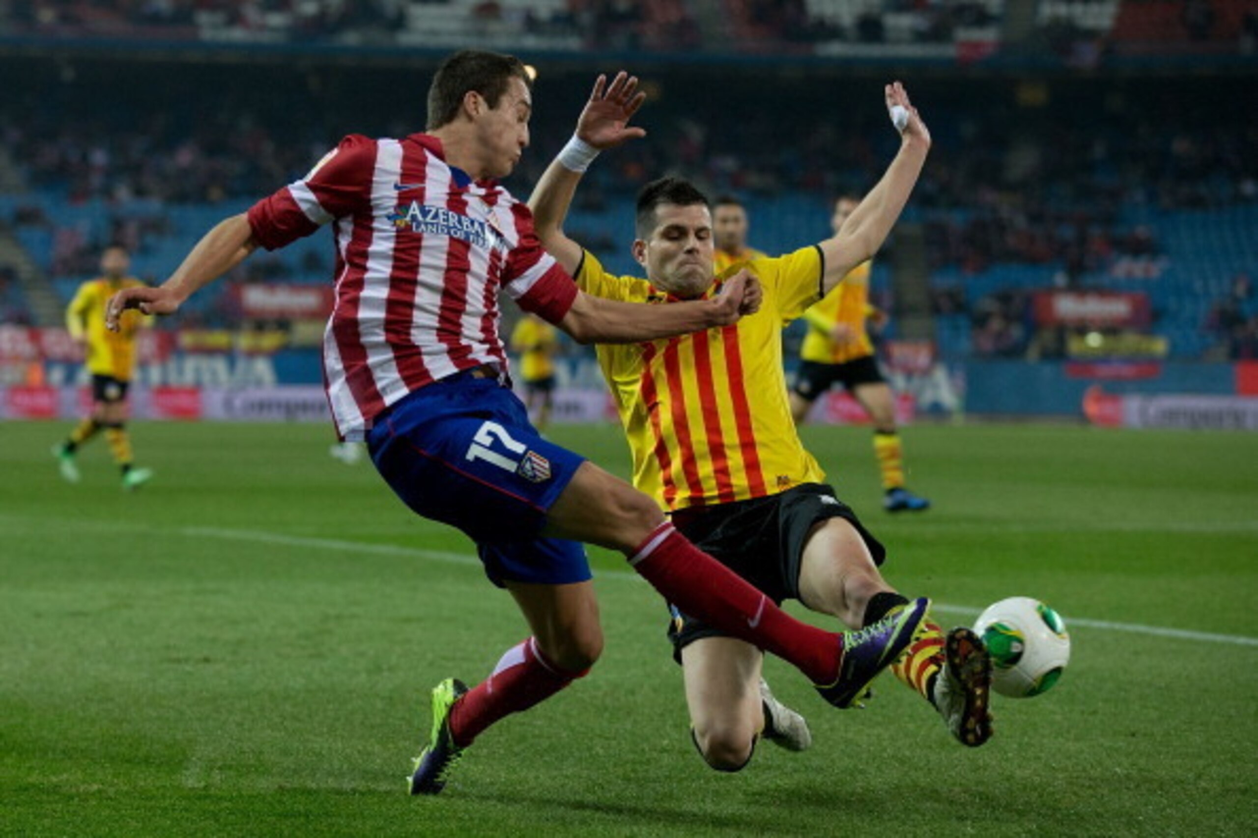 MADRID, SPAIN - DECEMBER 18: Javier Manquillo (L) of Atletico de Madrid competes for the ball with Alberto Rodriguez Carroza (R) during the Copa del Rey Round of 32 second leg match between Club Atletico de Madrid and Sant Andreu at Vivente Calderon Stadi