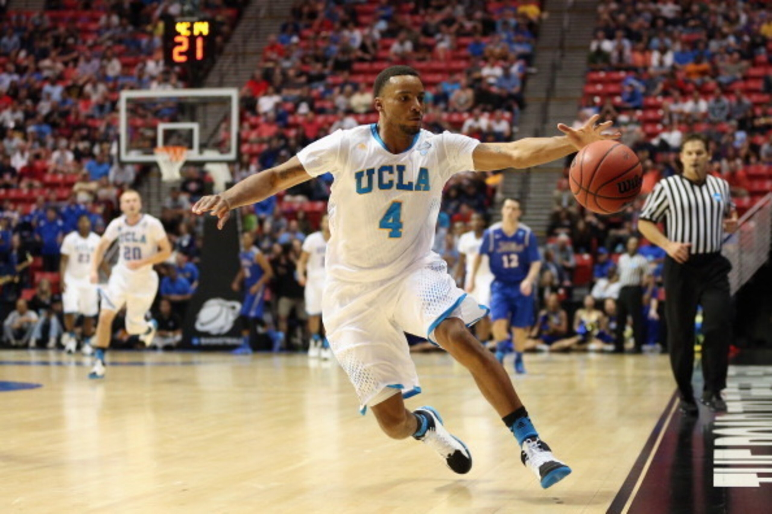 SAN DIEGO, CA - MARCH 21:  Norman Powell #4 of the UCLA Bruins saves the ball from going out of bounds against the Tulsa Golden Hurricane during the second round of the 2014 NCAA Men's Basketball Tournament at Viejas Arena on March 21, 2014 in San Diego, 