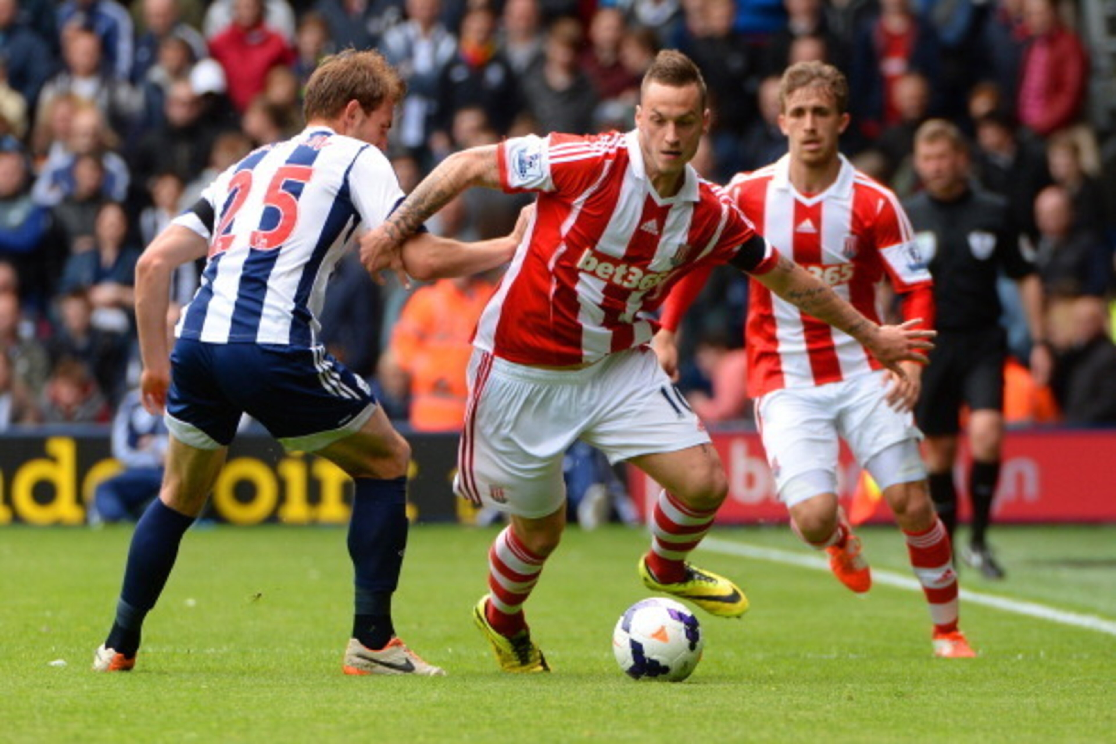 WEST BROMWICH, ENGLAND - MAY 11: Marko Arnautovic of Stoke City evades Craig Dawson of West Bromwich Albion during the Barclays Premier League match between West Bromwich Albion and Stoke City at The Hawthorns on May 11, 2014 in West Bromwich, England. WEST BROMWICH, ENGLAND - MAY 11: Marko Arnautovic of Stoke City evades Craig Dawson of West Bromwich Albion during the Barclays Premier League match between West Bromwich Albion and Stoke City at The Hawthorns on May 11, 2014 in West Bromwich, England.