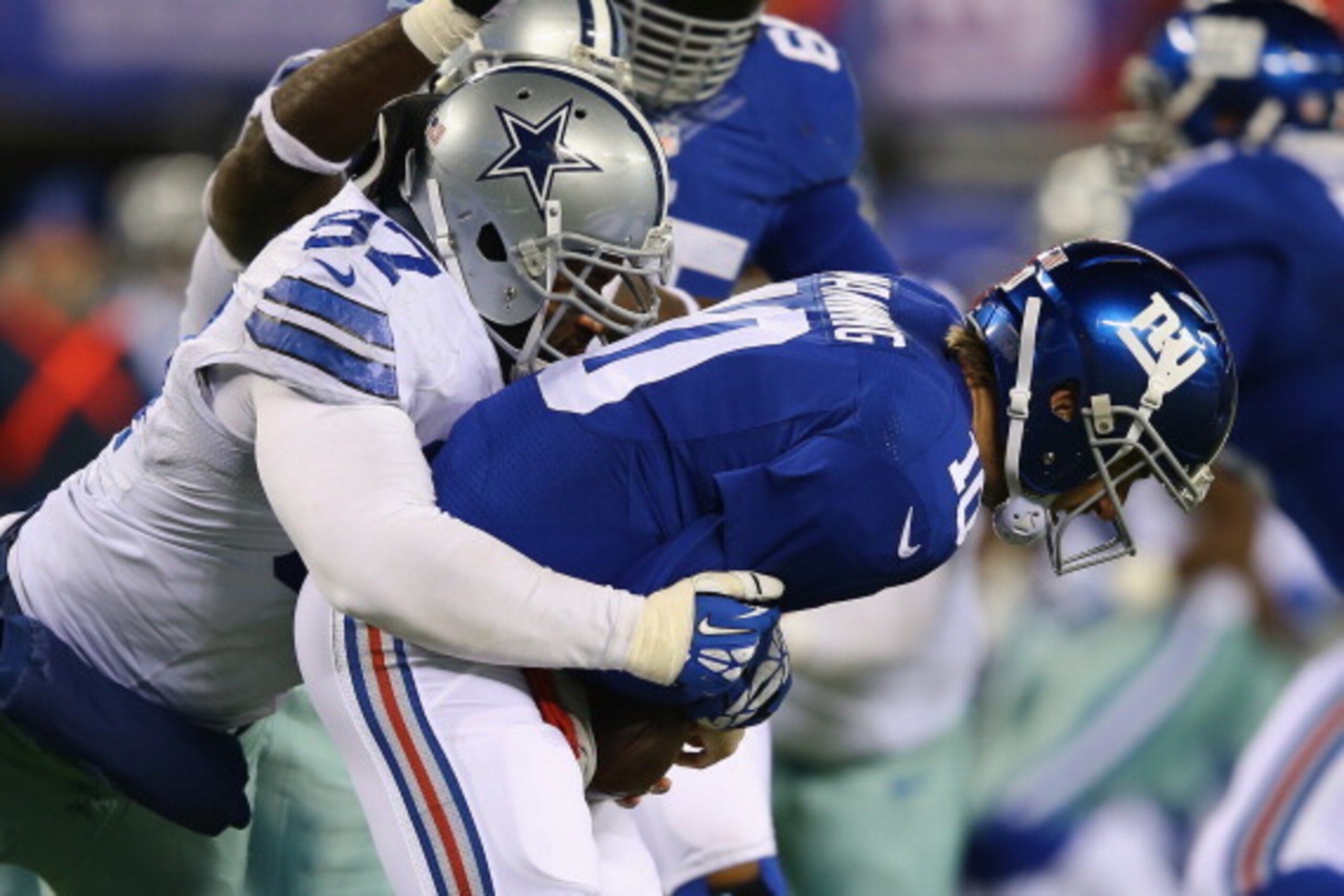 EAST RUTHERFORD, NJ - NOVEMBER 24:  Jason Hatcher #97 of the Dallas Cowboys sacks  Eli Manning #10 of the New York Giants during their game at MetLife Stadium on November 24, 2013 in East Rutherford, New Jersey.  (Photo by Al Bello/Getty Images)