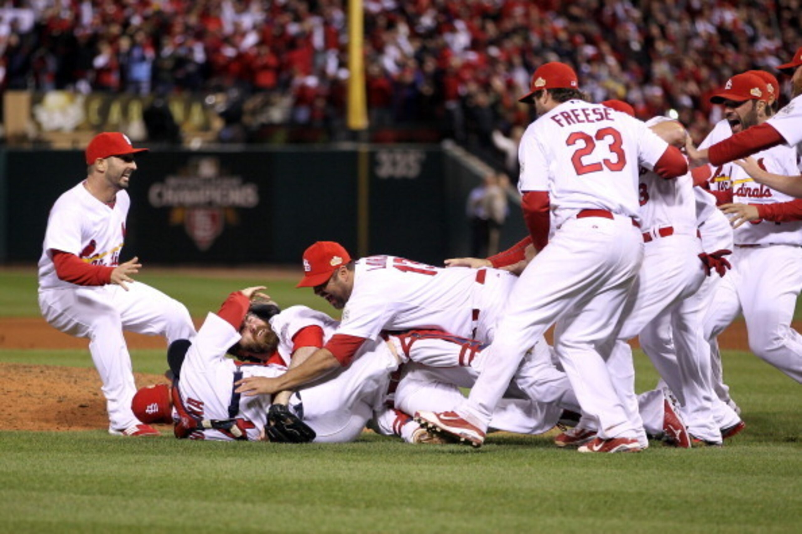 ST LOUIS, MO - OCTOBER 28:  Jason Motte #30 and Yadier Molina #4 of the St. Louis Cardinals celebrate after defeating the Texas Rangers 6-2 to win Game Seven of the MLB World Series at Busch Stadium on October 28, 2011 in St Louis, Missouri.  (Photo by Ez