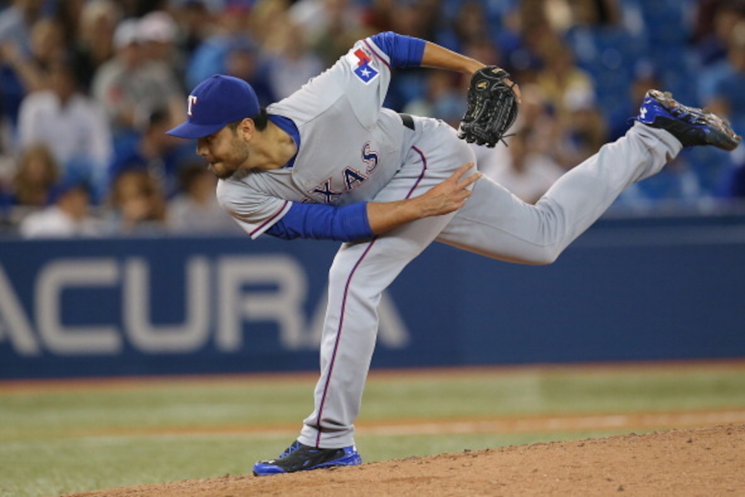 TORONTO, CANADA - JULY 18: Joakim Soria #28 of the Texas Rangers delivers a pitch in the ninth inning during MLB game action against the Toronto Blue Jays on July 18, 2014 at Rogers Centre in Toronto, Ontario, Canada. (Photo by Tom Szczerbowski/Getty Imag TORONTO, CANADA - JULY 18: Joakim Soria #28 of the Texas Rangers delivers a pitch in the ninth inning during MLB game action against the Toronto Blue Jays on July 18, 2014 at Rogers Centre in Toronto, Ontario, Canada. (Photo by Tom Szczerbowski/Getty Imag