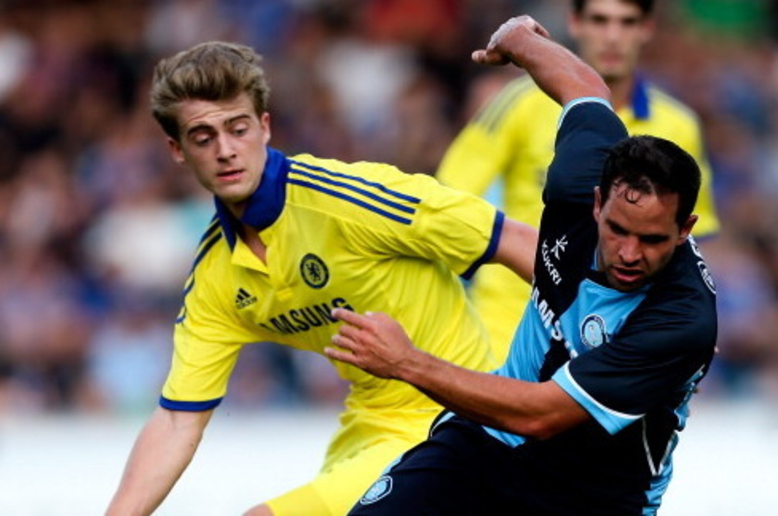HIGH WYCOMBE, ENGLAND - JULY 16:  Sam Wood of Wycombe holds off the challenge of Marco van Ginkel of Chelsea duing the pre season friendly match between Wycombe Wanderers and Chelsea at Adams Park on July 16, 2014 in High Wycombe, England.  (Photo by Ben 