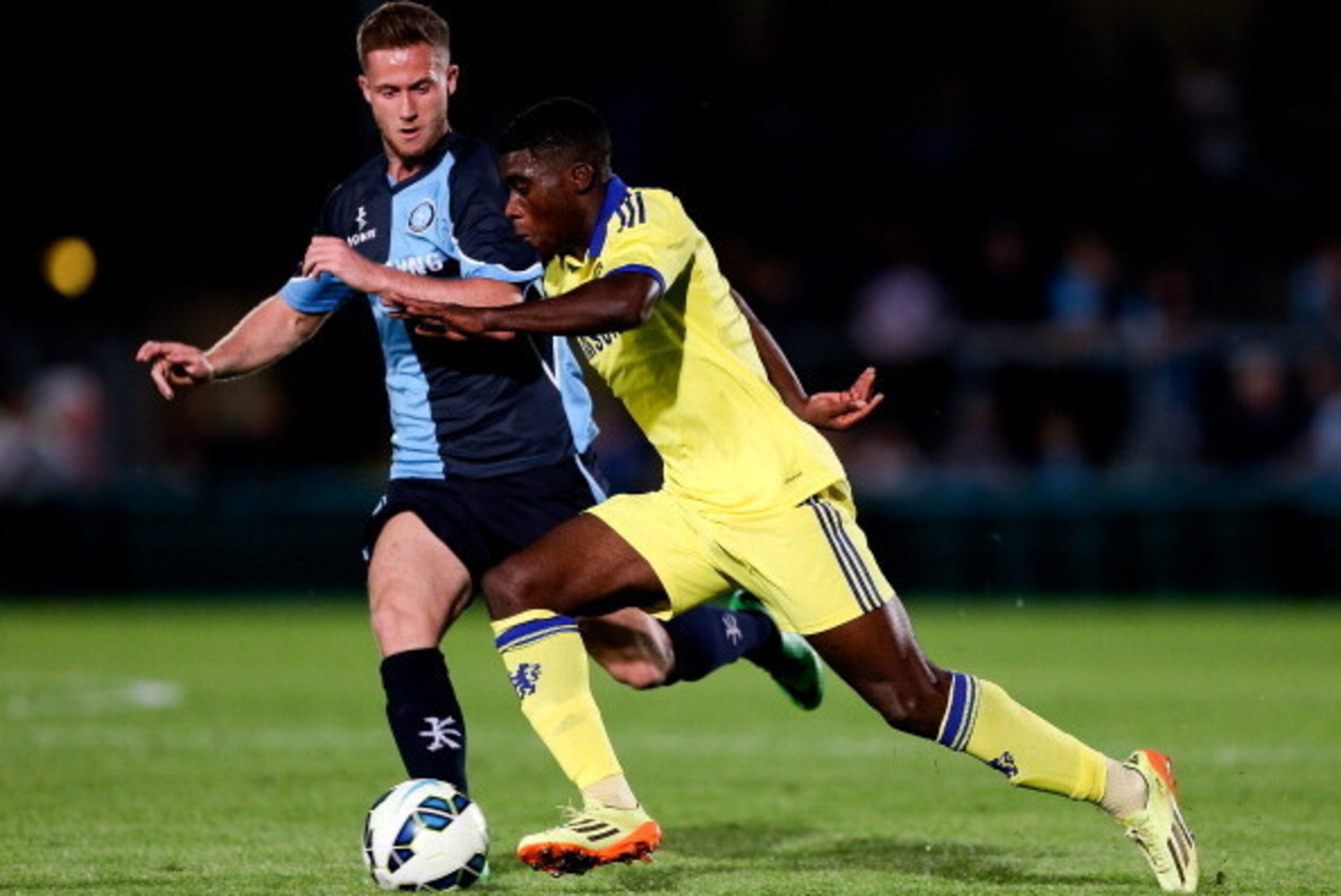 HIGH WYCOMBE, ENGLAND - JULY 16: Jeremie Boga of Chelsea advances under pressure from Nathan Evans of Wycombe duing the pre season friendly match between Wycombe Wanderers and Chelsea at Adams Park on July 16, 2014 in High Wycombe, England.  (Photo by Ben