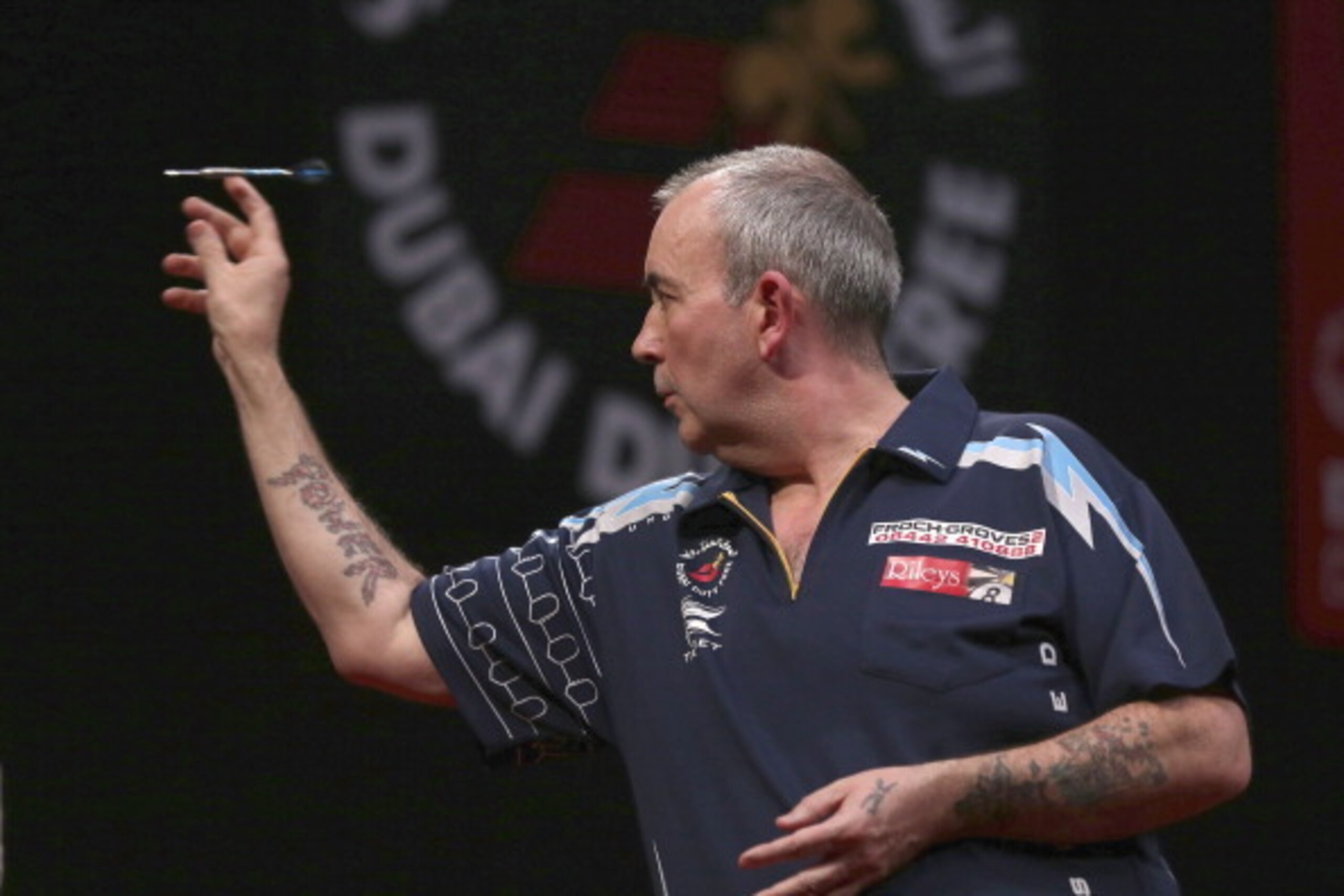 DUBAI, UNITED ARAB EMIRATES - MAY 29:  Phil Taylor of England plays against Peter Wright of England  during the 2014 Dubai Duty Free Darts Masters Quarter-Final match at Dubai Duty Free Tennis Stadium, Irish Village on May 29, 2014 in Dubai, United Arab E