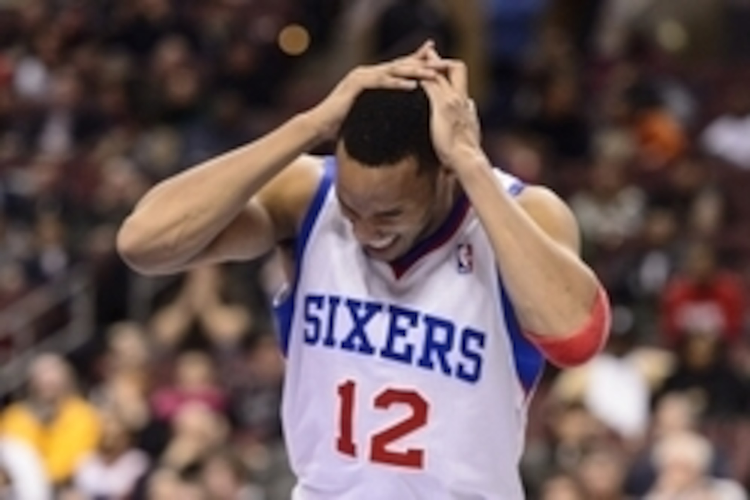 Jan 27, 2014; Philadelphia, PA, USA; Philadelphia 76ers guard Evan Turner (12) grabs his head after being hit during the fourth quarter against the Phoenix Suns at the Wells Fargo Center. The Suns defeated the Sixers 124-113. Mandatory Credit: Howard Smit
