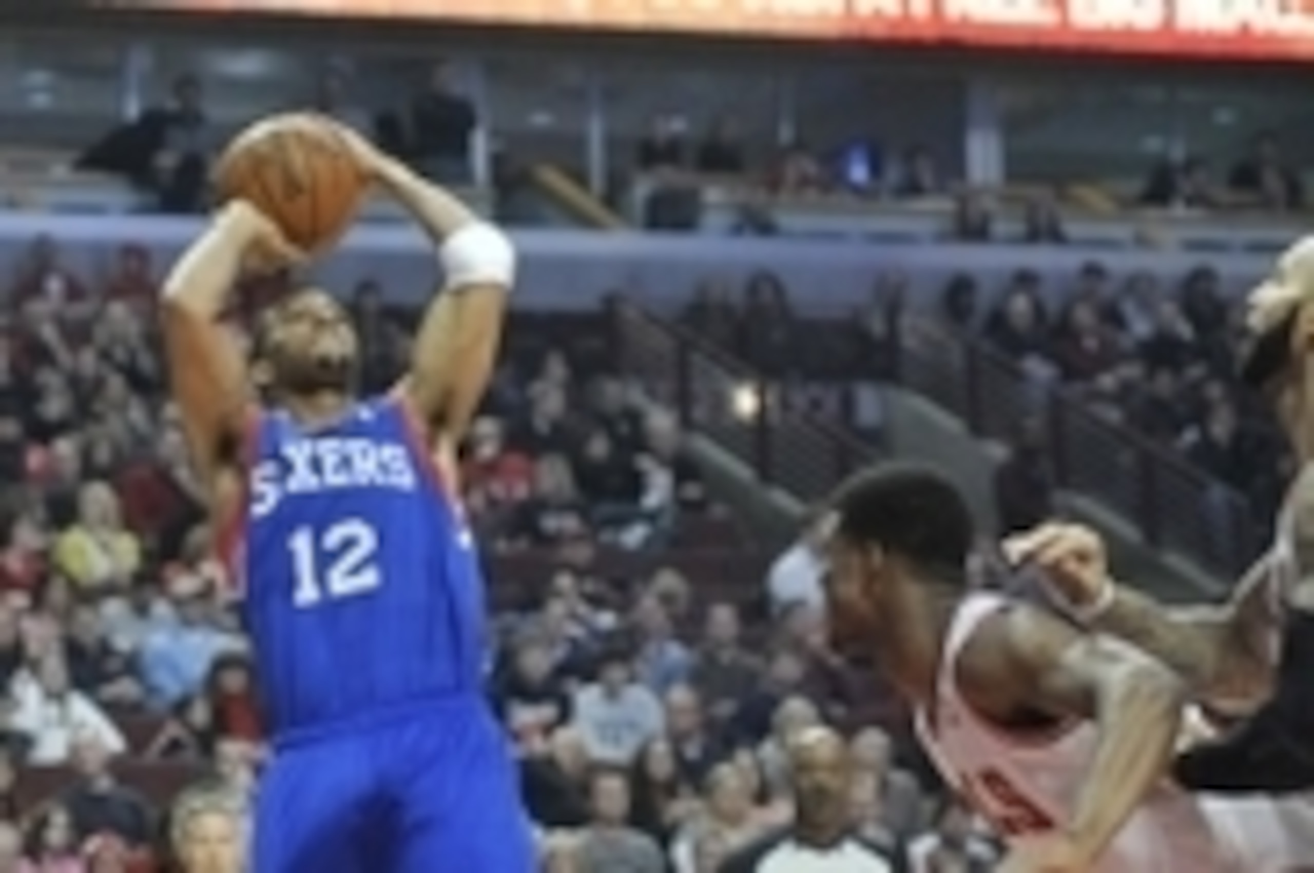 Jan 18, 2014; Chicago, IL, USA; Philadelphia 76ers small forward Evan Turner (12) shoots over Chicago Bulls shooting guard Jimmy Butler (21) during the first quarter at the United Center. Mandatory Credit: David Banks-USA TODAY Sports