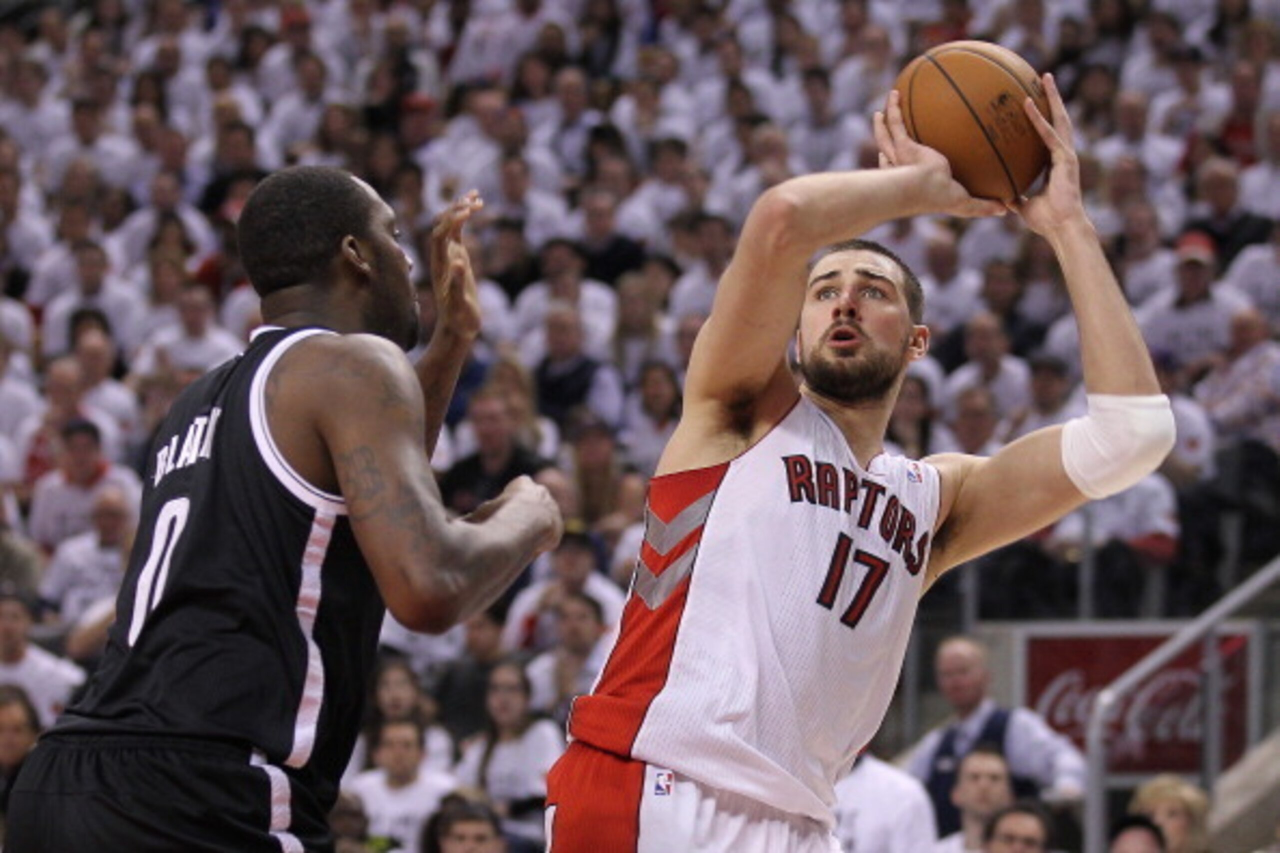 TORONTO, ON - MAY 04:  Jonas Valanciunas #17 of the Toronto Raptors tries to make a shot over Andray Blatche #0 of the Brooklyn Nets in Game Seven of the NBA Eastern Conference Quarterfinals at the Air Canada Centre on May 4, 2014 in Toronto, Ontario, Can