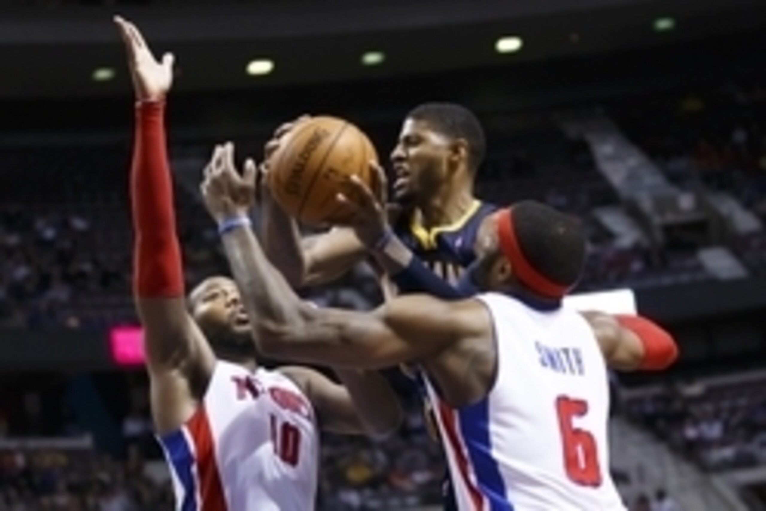 Mar 15, 2014; Auburn Hills, MI, USA; Indiana Pacers forward Paul George (24) goes to the basket defended by Detroit Pistons forward Greg Monroe (10) and forward Josh Smith (6) in the fourth quarter at The Palace of Auburn Hills. Indiana won in overtime 11