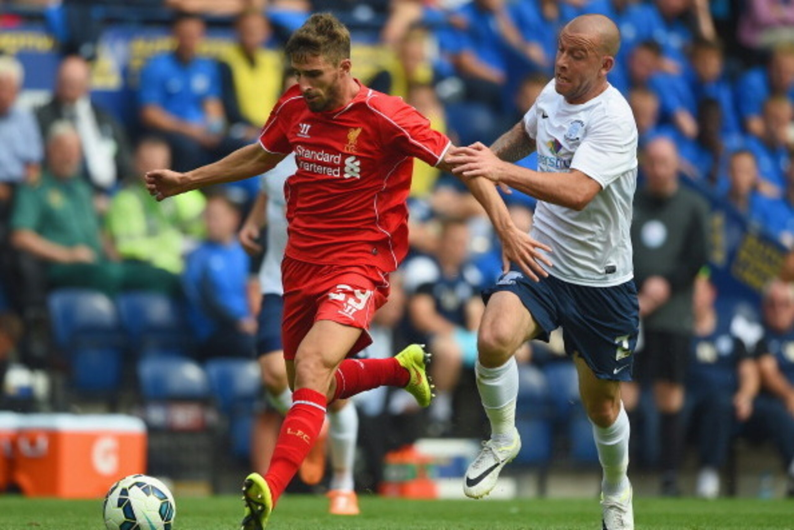PRESTON, LANCASHIRE - JULY 19:  Keith Keane of Preston in action with Fabio Borini of Liverpool during the pre season friendly match between Preston North End and Liverpool at Deepdale on July 19, 2014 in Preston, Lancashire.  (Photo by Michael Regan/Gett