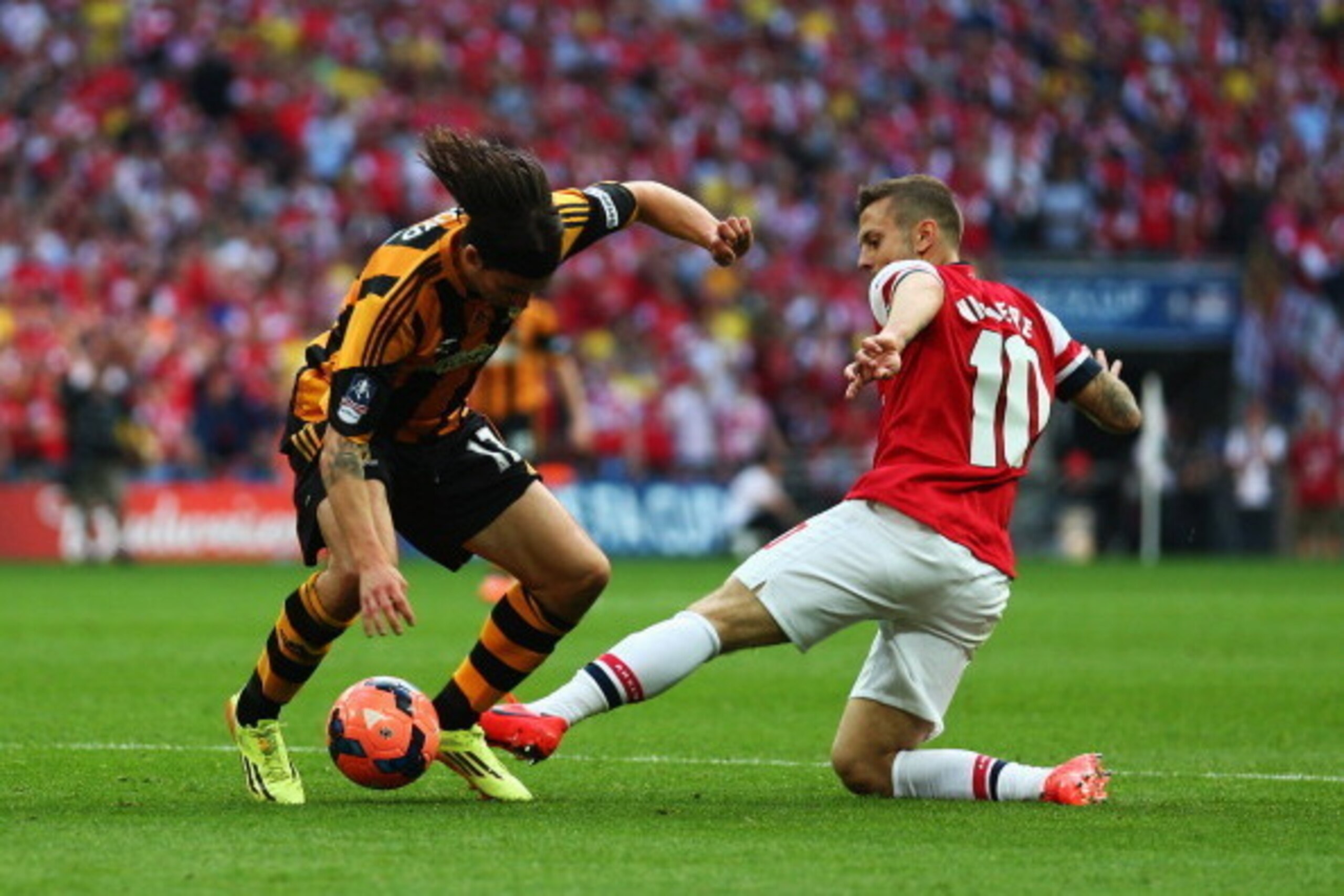 LONDON, ENGLAND - MAY 17:  George Boyd of Hull City is tackled by Jack Wilshere of Arsenal  the FA Cup with Budweiser Final match between Arsenal and Hull City at Wembley Stadium on May 17, 2014 in London, England.  (Photo by Paul Gilham/Getty Images)