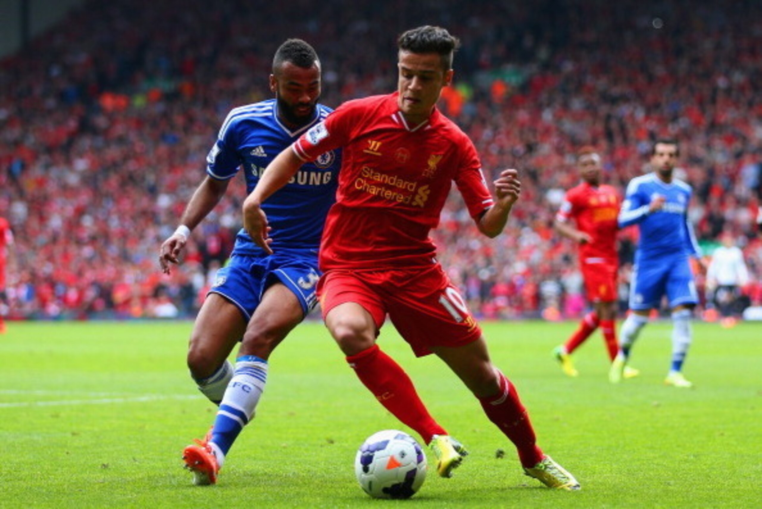 LIVERPOOL, ENGLAND - APRIL 27: Ashley Cole of Chelsea and Philippe Coutinho of Liverpool compete for the ball during the Barclays Premier League match between Liverpool and Chelsea at Anfield on April 27, 2014 in Liverpool, England.  (Photo by Clive Bruns