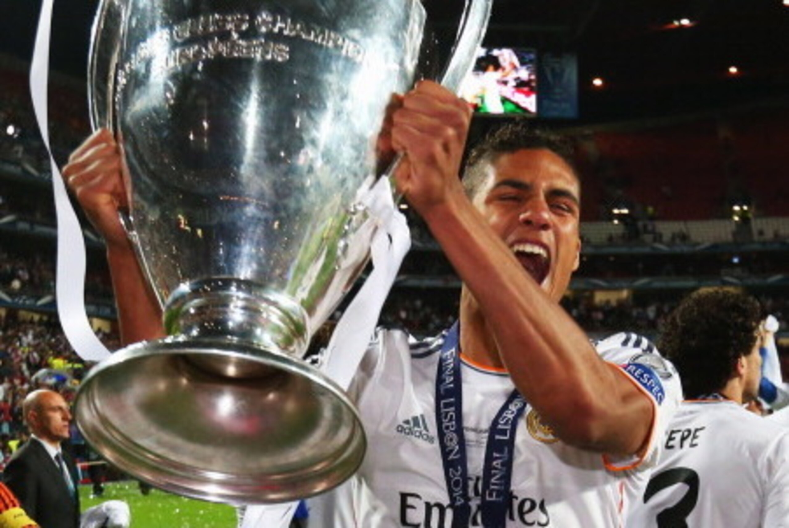 LISBON, PORTUGAL - MAY 24:  Raphael Varane of Real Madrid celebrates victory with the trophy after the UEFA Champions League Final between Real Madrid and Atletico de Madrid at Estadio da Luz on May 24, 2014 in Lisbon, Portugal.  (Photo by Alex Livesey/Ge