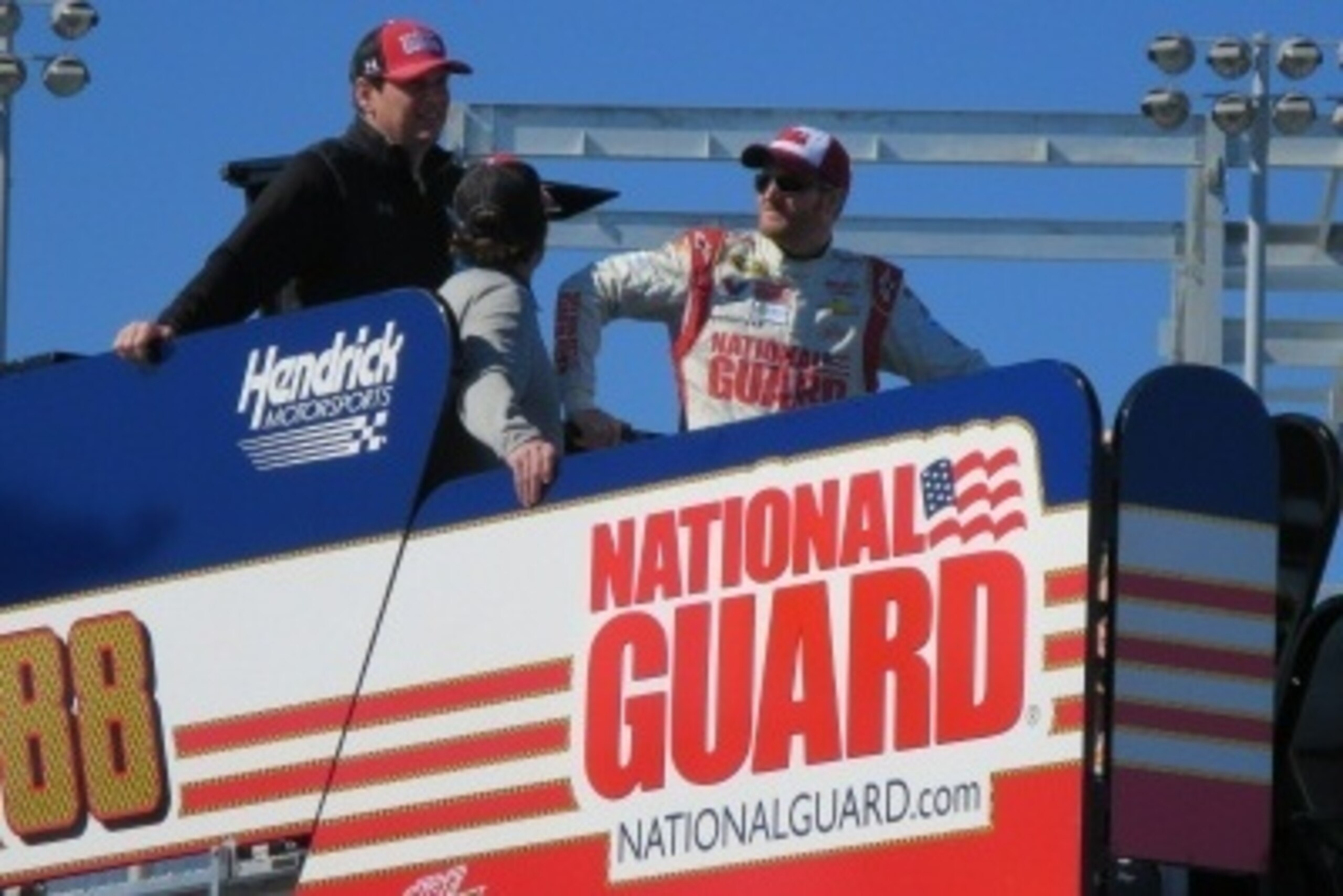 Dale Earnhardt Jr and team watch practice at Daytona International Speedway on top of the No. 88 hauler.
