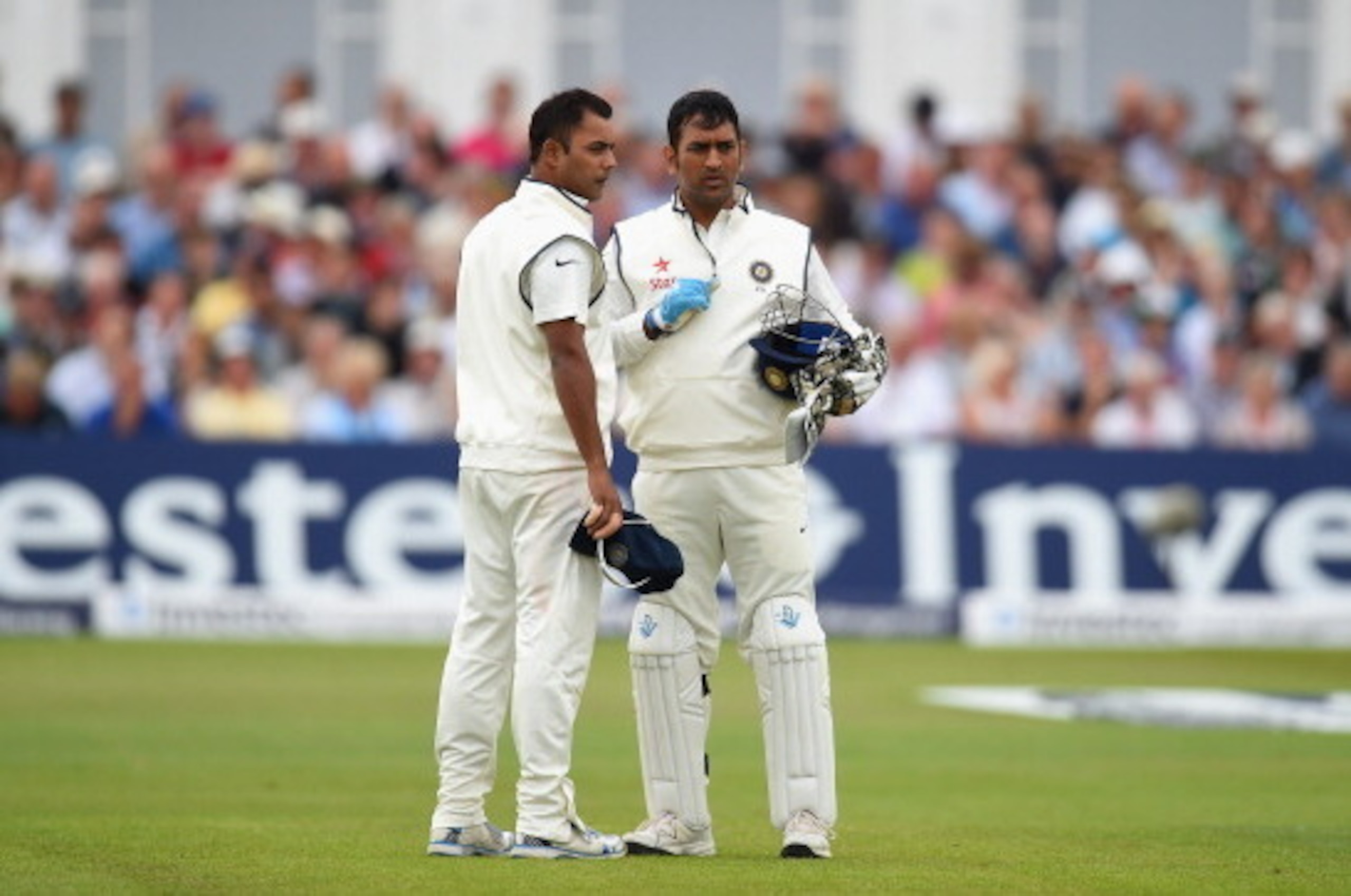 NOTTINGHAM, ENGLAND - JULY 11: India captain Mahendra Singh Dhoni (r) and bowler Stuart Binny chat during day three of the 1st  Investec Test Match between England and India at  Trent Bridge on July 11, 2014 in Nottingham, England.  (Photo by Stu Forster/