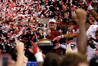 NEW ORLEANS, LA - JANUARY 02:  Head coach Bob Stoops of the Oklahoma Sooners celebrates with the winner's trophy after defeating the Alabama Crimson Tide 45-31 during the Allstate Sugar Bowl at the Mercedes-Benz Superdome on January 2, 2014 in New Orleans