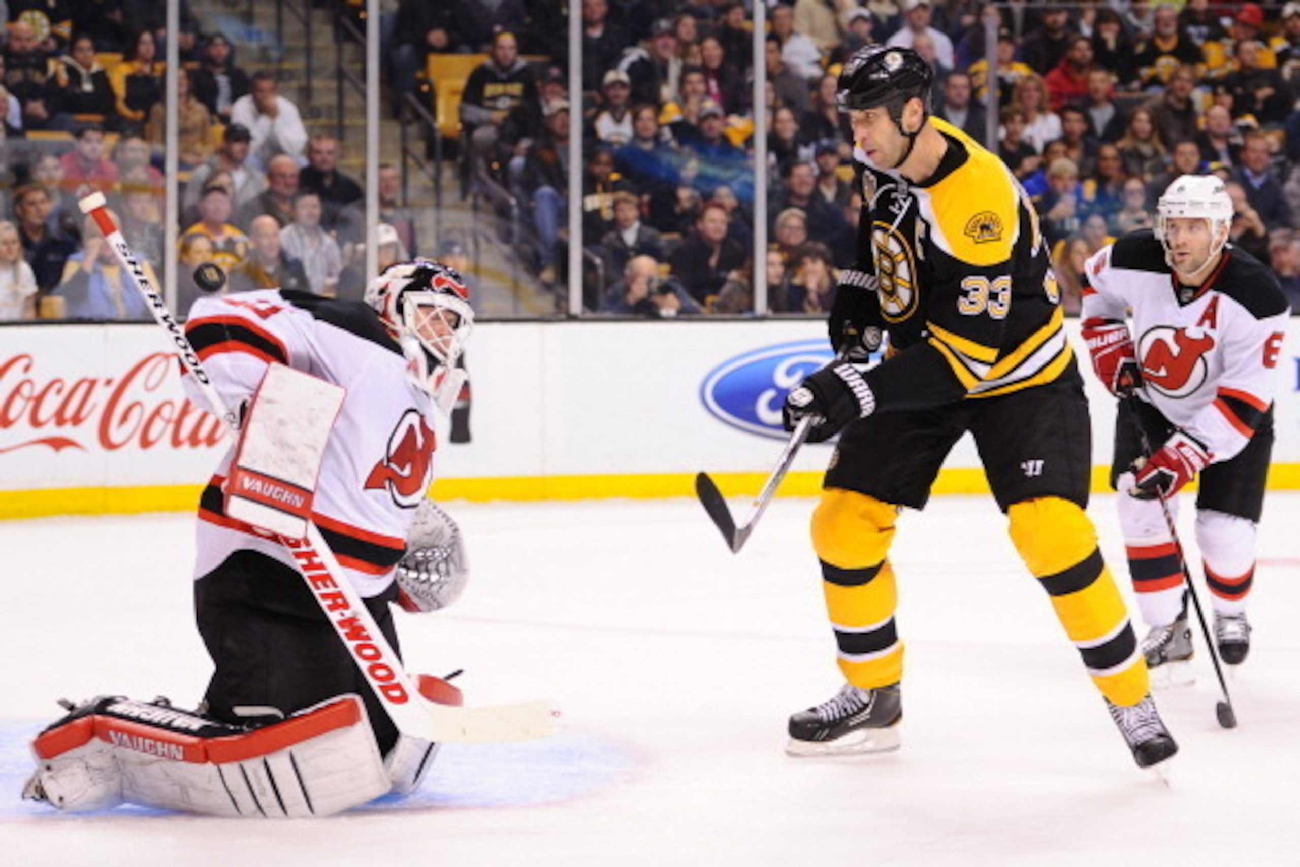 BOSTON, MA - OCTOBER 26: Zdeno Chara #33 of the Boston Bruins looks at the mid air loose puck against Martin Brodeur #30 of the New Jersey Devils at the TD Garden on October 26, 2013 in Boston, Massachusetts.  (Photo by Brian Babineau/NHLI via Getty Image